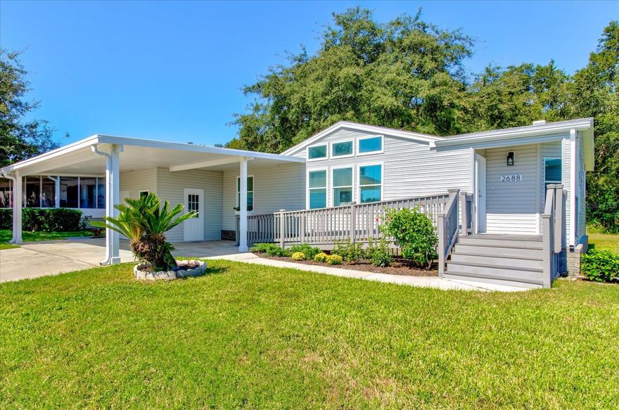 This is the one you've been waiting for!! You won't want to miss this spacious Palm Harbor home located in the sought after pet area in Zellwood Station! This home is very well-maintained, has high ceilings and great natural lighting! Ready to move in and enjoy with all the work already done! New Roof 2022, Re-plumb 2022, New A/C 2023, New Hot Water Heater 2022, Exterior Paint 2023, Interior Paint 2022, Kitchen Upgrades 2023 include kitchen counters and tile backsplash, new kitchen sink and faucet, new pantry with pull out shelving, New Paver Patio 2022 and New Accessibility Ramp and landscaping in 2023. The primary bedroom includes a walk in closet, an oversized en suite bathroom with ample counter space, double sinks, new ADA toilet, and a new glass shower door. There is an indoor laundry room and the washer and dryer convey. All of this and a great oversized Florida Room with a new portable A/C unit to enjoy the peaceful view off this premium lot. This is a must see home! Zellwood Station is a Resident Owned 55+ Golfing Community located between Apopka and Mt Dora. There is a 72 Par golf course, 4 pools, pickleball and tennis courts; water exercise and line dancing classes and the Whistle Stop Restaurant and Lounge with banquet facilities.This is a Guard Gated and Resort Style Community with all the amenities and activities for you to enjoy!