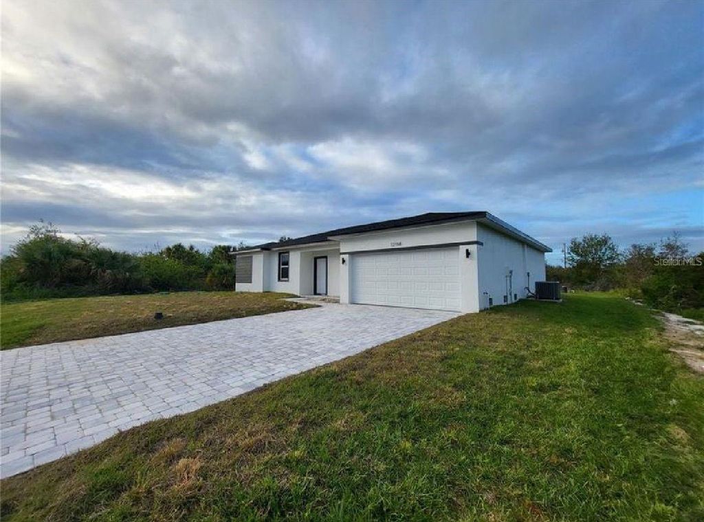 Photo of 12176 Henley Ave, Port Charlotte, FL 33981 (MLS # TB8446305)