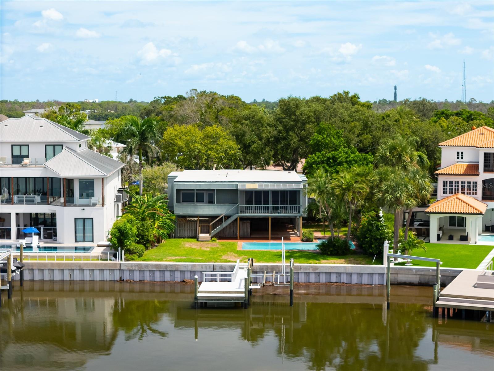 Welcome to 130 Carlyle Drive, where the essence of Florida’s Gulf Coast lifestyle comes to life. Direct Gulf of America access. New Dock and Seawall 2023. Nestled within the highly desirable enclave of Indian Bluff Island, this residence offers more than just a home—it offers a way of living defined by natural beauty, coastal charm, and vibrant community spirit.
With over 2,200 square feet of living space on nearly a third of an acre, the home provides a comfortable and flexible floor plan with a blend of tile and carpeted floors. Sun-filled interiors create a warm and inviting atmosphere, while spacious gathering areas make it easy to entertain or unwind in complete comfort.
Step outside your front door and explore everything Palm Harbor is known for. Tee off at the world-class Innisbrook Golf Resort & Spa, home of the PGA Valspar Championship, or connect with nature at Wall Springs Park, a 210-acre preserve with boardwalks, a natural spring, and sweeping observation tower views. Enjoy lakeside adventures at John Chesnut Sr. Park on Lake Tarpon, or bike and jog along the scenic Pinellas Trail that winds through the heart of Pinellas County.
When it’s time to relax by the water, you’re only minutes from the sugar-sand beaches of Honeymoon Island State Park and the ferry to Caladesi Island, two of Florida’s most cherished natural escapes. For dining and entertainment, head to charming downtown Palm Harbor or the waterfront village of Ozona, where you’ll find local restaurants, boutique shops, and community events like First Fridays and the annual Taste of Palm Harbor festival. Families will also appreciate access to top-rated schools, including the acclaimed Palm Harbor University High.
This home places you at the center of it all—where every day offers a new way to experience Florida’s coastal lifestyle. Whether you envision a private retreat, a place for entertaining, or a base for adventure, 130 Carlyle Drive delivers a rare combination of space, location, and opportunity in one of the most sought-after communities on the Gulf Coast.