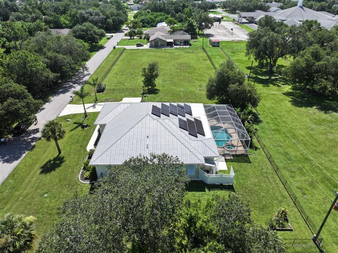 Nestled in the heart of Port Charlotte on a rarely available large lot of nearly an acre, this charming custom-built 3-bedroom, 2-bath pool home offers the perfect blend of space, comfort, and Florida lifestyle. Located in a quiet, well-maintained neighborhood just minutes from I-75, shopping, dining, and world-renowned Gulf beaches, this 2004 home boasts an airy open floor plan with split bedrooms—ideal for both families and entertaining guests. Solar was installed recently offering nearly free electricity for those seeking off the grid lifestyles. Step inside to find soaring volume ceilings, elegant porcelain tile throughout, and thoughtful details like a breakfast bar, dinette, and formal dining room. French doors lead to the lanai, and the oversized utility room, walk-in closets, extra storage, and a security system add both convenience and peace of mind. The spacious layout flows effortlessly, creating a warm and welcoming atmosphere throughout the home. Outside, enjoy the ultimate Florida lifestyle with a heated pool and spa featuring an upgraded Pebble Tec finish, decorative waterline tiles, and a beautiful brick paver deck. The lush landscaping, mature oak trees, privacy fence, and well-fed irrigation system enhance the serene outdoor setting. A durable metal roof and water softening system round out the extensive list of exterior features. This meticulously maintained property truly has it all—space, upgrades, and location. Port Charlotte continues to earn top honors as one of the best places to retire, as recognized by Where to Retire and Money magazine. Don’t miss your opportunity to own a piece of paradise in one of Florida’s most desirable communities.