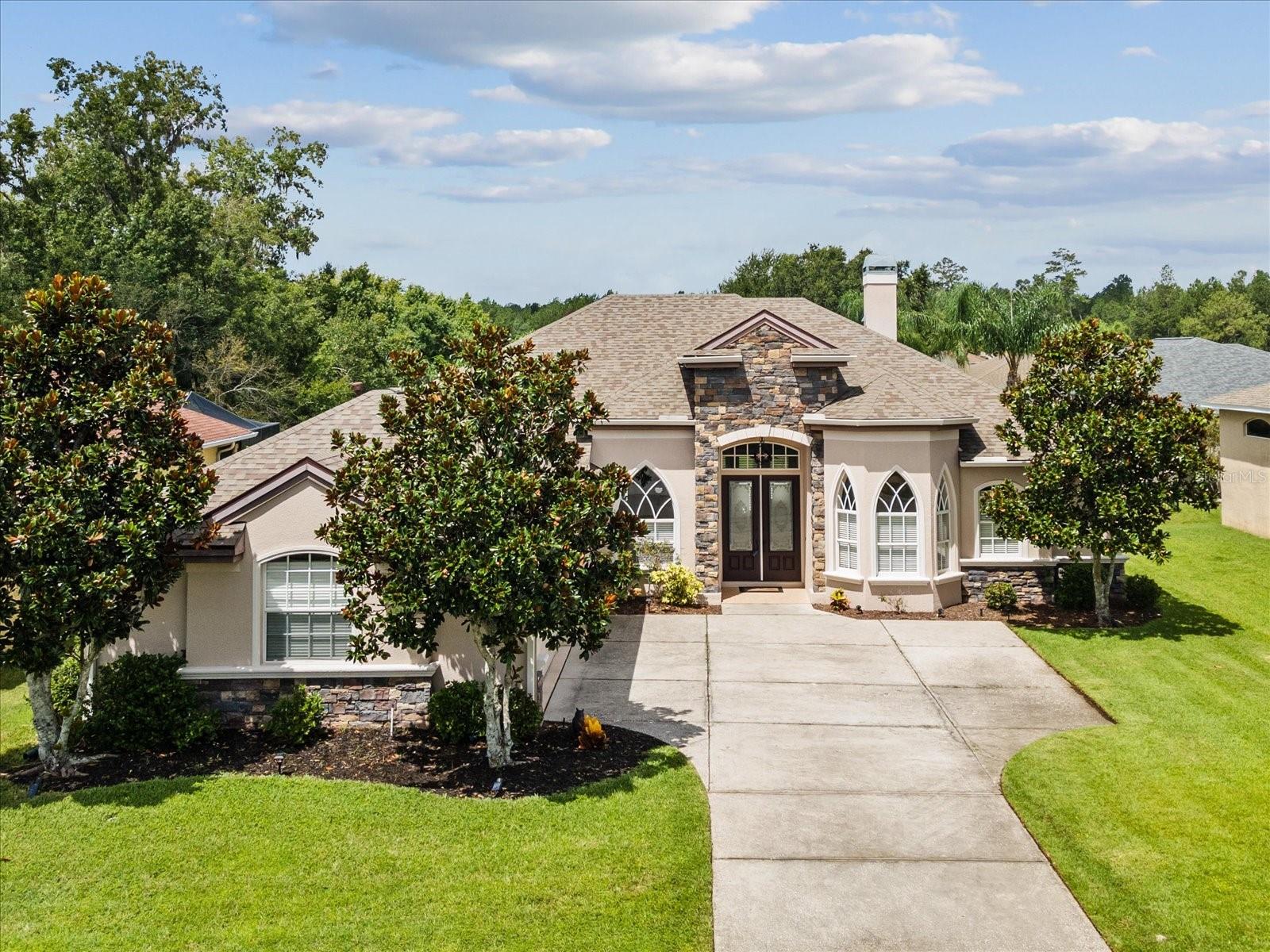 Gorgeous single-family home located in the gated golfing community of Hernando Oaks. This spacious property offers 4 bedrooms, 3 bathrooms, a 3-car garage, and a fully fenced backyard with serene pond views from the covered back porch. Enter through elegant glass double doors into a bright foyer that opens to a flowing layout, including formal dining, living, and family rooms with built in shelving and wood burning fireplace. The open floor plan is ideal for both relaxing and entertaining. On the right side of the home, the private primary suite features direct access to the back porch, two walk-in closets, and a luxurious ensuite bathroom with dual sink areas, a garden tub, standing shower, and a separate water closet. On the opposite side, two additional bedrooms share a full hallway bathroom with a tub/shower combo. Toward the rear of the home, a private fourth bedroom includes a walk-in closet, its own full bathroom with a walk-in shower, and access to the back porch—perfect for use as an in-law suite or guest space. The heart of the home is the spacious kitchen, which includes abundant cabinetry and counter space, a center island, breakfast bar, and a cozy breakfast nook. The side-entry 3-car garage opens into a functional laundry room equipped with a sink and a built-in desk/drop zone area. Situated on a quiet cul-de-sac, this home offers privacy, comfort, and beautiful views in a sought-after community. Roof (2023), HVAC system (2020). Community amenities include a professionally designed Scott Pate 18-hole golf course spanning 6,905 yards, a pro shop, restaurant overlooking the golf course, pickleball courts, and monthly activities—all just minutes from shopping, dining, and essential services. This is more than just a home—it’s a lifestyle. Schedule your private showing today!