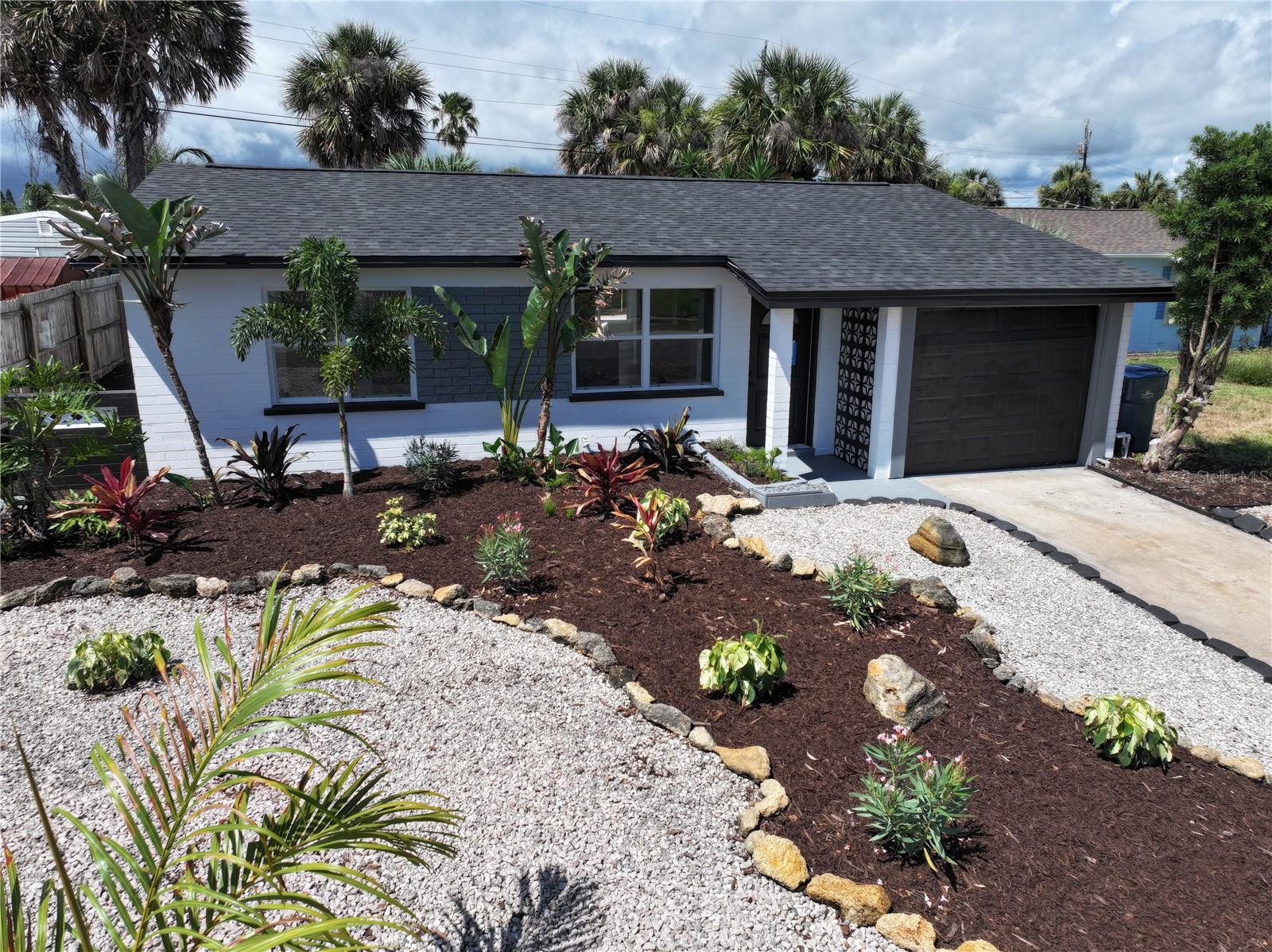 The most CHARMING seaside bungalow awaits you in the exclusive community of Ormond By The Sea! This beautiful seaside home has been fully updated inside and out with a New Roof 2024, White shaker wood cabinets, stainless appliances, quartz countertops, porcelain tile throughout and a gorgeous oversized bathroom. Spend your days soaking in the sun with less than a 3 minute walk to the beach! The home features 2 bedrooms and 1 large bathroom with a large living area and kitchen. The back Florida room is an incredible place to relax at all times of the day. The private fenced in back yard is perfect for entertaining! The concrete slab in the back of the home was made for shuffle board or use it for patio furniture or sun loungers. The home is nestled between the Intercoastal and the Beach! NEW SEPTIC TANK 2024!!!!