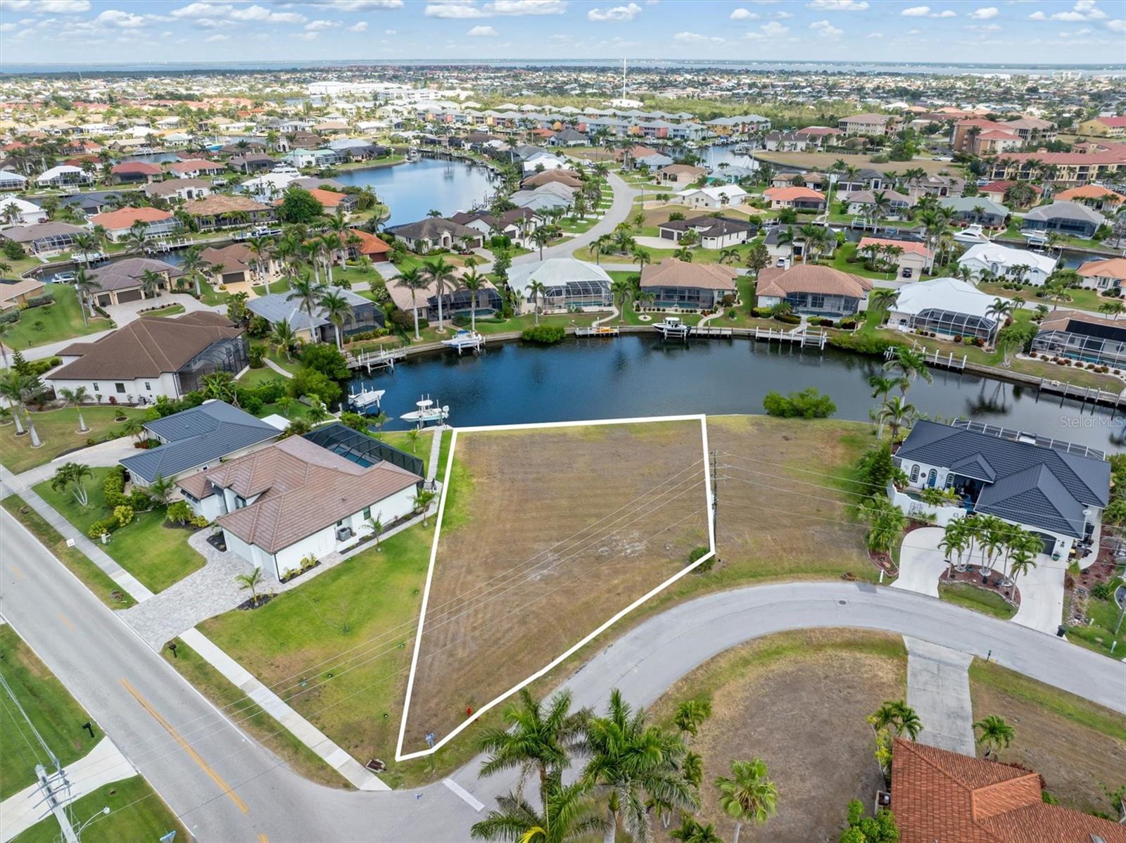 Build your waterfront dream home in the highly sought-after Punta Gorda Isles! This premium Gulf-access lot offers sailboat access with no bridges—perfect for avid boaters. Located on a wide canal with city-maintained concrete seawalls, this property provides peace of mind and immediate value. Enjoy quick access through Buckley’s Pass to Alligator Creek, Charlotte Harbor, and the Gulf of Mexico. Whether you're heading out for a day of deep-sea fishing or a sunset cruise, your private dock-to-open-water experience starts in your backyard. Nestled among upscale homes in a thriving boating and golf community, and just minutes from historic downtown Punta Gorda, shopping, dining, and waterfront parks. Don't miss this rare opportunity to own a piece of paradise with year-round boating, warm breezes, and endless Florida sunshine.