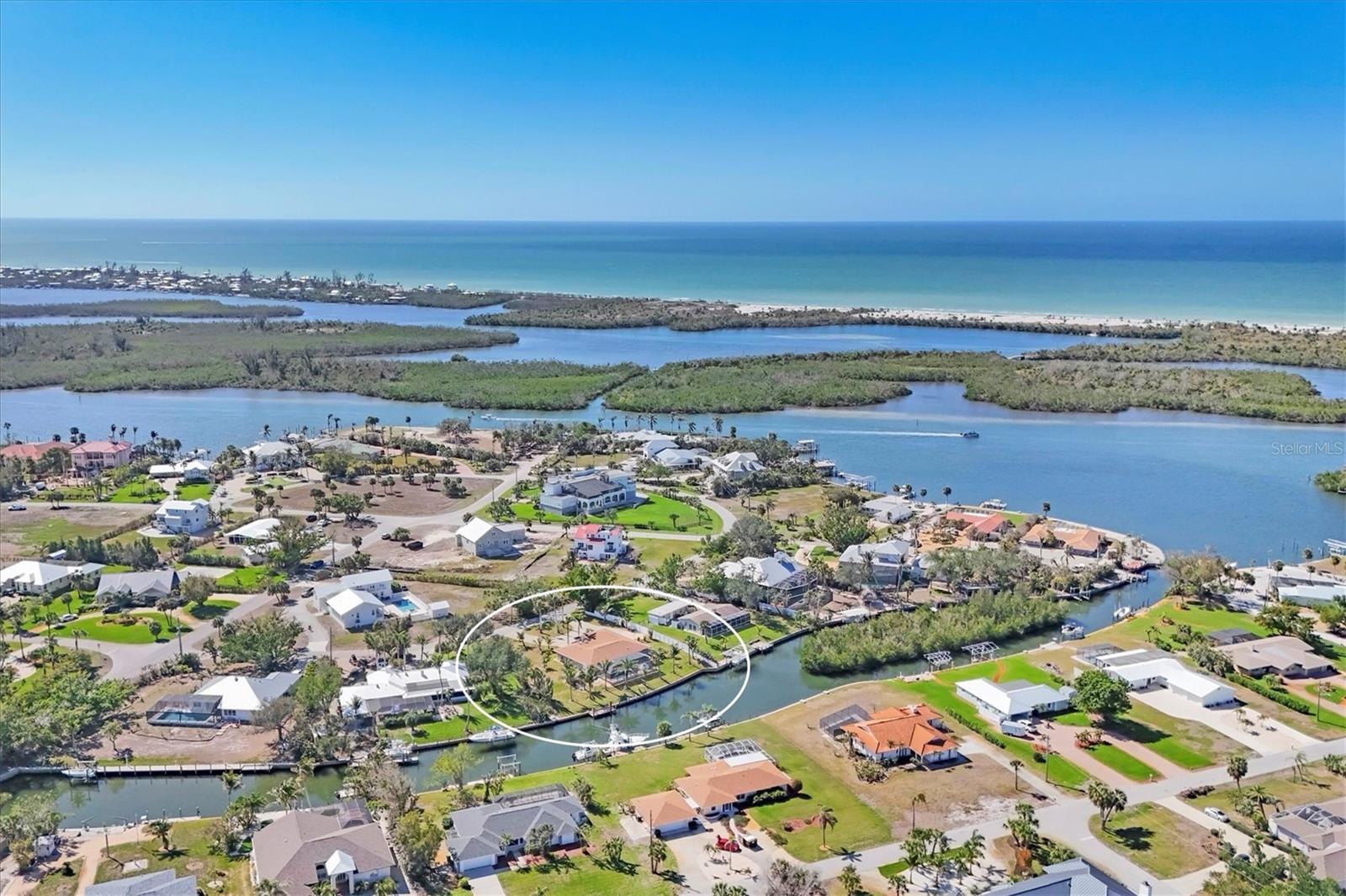 Welcome to this incredible boater's paradise! This stunning property boasts over 172 feet of deep-water canal frontage, offering direct access with no bridges to the Intracoastal Waterway and the Gulf of Mexico. Located in the coveted Vanderbilt-developed neighborhood of Cape Haze, this home sits on a spacious .53-acre lot, just 4 lots in from the ICW. Perfectly designed for boat enthusiasts, the property features a concrete seawall and a large Trex boat dock, and out pilings, making it ideal for vessels of all sizes. Cape Haze is renowned for its proximity to world-class fishing and endless boating destinations, including the historic Boca Grande, Sanibel Island, Cabbage Key, Punta Gorda's Fisherman's Village, and Manasota Key. Wildlife lovers will delight in the secluded waterfront location, where birds and fish abound, creating a peaceful, natural setting. The exterior of the home features a circular driveway, a side-entry garage, and mature landscaping. A charming courtyard patio at the front entry offers a welcoming touch. Upon entering, you are greeted by an expansive open floor plan with three sets of sliding doors that offer stunning views of the pool, paver lanai, and panoramic wide canal views.The outdoor patio area is perfect for relaxing or entertaining, featuring a large heated, saltwater pool (built in 2018) and plenty of room for lounging in a chaise. The spacious yard is ideal for pets or outdoor activities. Inside, the updated eat-in kitchen opens into a large dining and living area, with views of the water from the sink. The kitchen boasts stone countertops, stainless steel appliances, and a walk-in pantry. The home offers two large living rooms, both with picturesque views of the surrounding paradise. The primary suite is a serene retreat, featuring a walk-in closet and dual vanities in the bath. The home is thoughtfully designed with tile flooring throughout, a recently updated bath, mature landscaping, a newer irrigation pump, a newer pool pump, and a new roof (2023). Recent updates also include replaced plumbing waste pipes, stainless steel appliances, and newer A/C systems. The property is perfect for full or part time residents and also for those looking income producing property. The home has excellent rental history and existing leases in place. Conveniently located near essential shopping, numerous waterfront restaurants, three full-service marinas, and miles of serene sandy beaches on Boca Grande and Palm Island. You'll also find private and public golf courses nearby, making this an ideal location for both relaxation and adventure. This property is truly a one-of-a-kind opportunity for those seeking an unparalleled boater's lifestyle in a pristine, tropical setting.