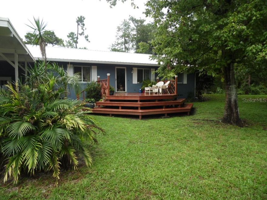 Are you looking for country peace and quiet yet still within minutes to everything the area has to offer? If so, then look no further. Virtually no neighbors in sight. This is an established area with no threat of the next subdivision being built next door. Sitting on just over 2.5 acres is this 3 bedroom 2.5 bath main house, a detached in-law cottage, a huge 1,260 sq foot shop with concrete floor and high roof line. A 15kw generator room that powers the property and 2 additional storage sheds. There's so much to enjoy here with the wood burning fire place for the cool winter nights. A great entertaining room that opens up to the in ground pool surrounded by lush tropical landscaping. Numerous recent upgrades done in 2018 for peace of mind including, a metal roof, Low E thermopane windows, electric panel, A/C, and water heater. Your house guests will have their own independence in the detached in-law with its own bathroom and kitchen. Guys bring your imagination for the workshop it has LOADS of potential. Got horses? Bring them and ride right out the front gate down the private dirt road. There are plenty of equestrian enthusiasts in the area as well as close proximity to the Rails to Trails bike path. Edgewater is growing and properties like this sitting high and dry outside the 500 year flood plane are becoming harder to find. Don't miss the chance to own yours. Schedule your showing today.