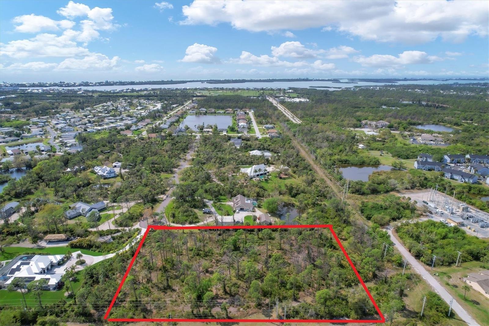 Over 3.25 Acres located in the private gated community of Heritage Oaks at Shamrock Shores. Bring your house plans and build on this gorgeous spacious property with room for a main house, a large garage / shed or barn, or add a small guest house. The options on this property are endless. The land has been hydro-mulched, partially cleared, soil tested and surveyed including environmental surveys which are all available upon request. This gated community has a newly paved private road to all of the home sites which are all over an acre and this is the ONLY lot left for sale. In addition, a NEW WATER METER has been connected directly to the property (public water source). This is a big savings of approximately $15k in impact fees. Heritage Oaks at Shamrock Shores allows you to have small animals (Charlotte County zone codes, see more of what’s allowed on the property). This gorgeous property is centrally located between Sarasota and Fort Myers and has easy access to I-75 and many airports. Just minutes from beautiful beaches, golf, shopping, and restaurants. Enjoy the Florida lifestyle by living your best life on this fantastic property, building your dream home, enjoying the beaches, relaxing by your pool, and soaking up the sunshine! You have to see it to believe it! Note: The Sellers have house plans that are available for purchase if you are interested.