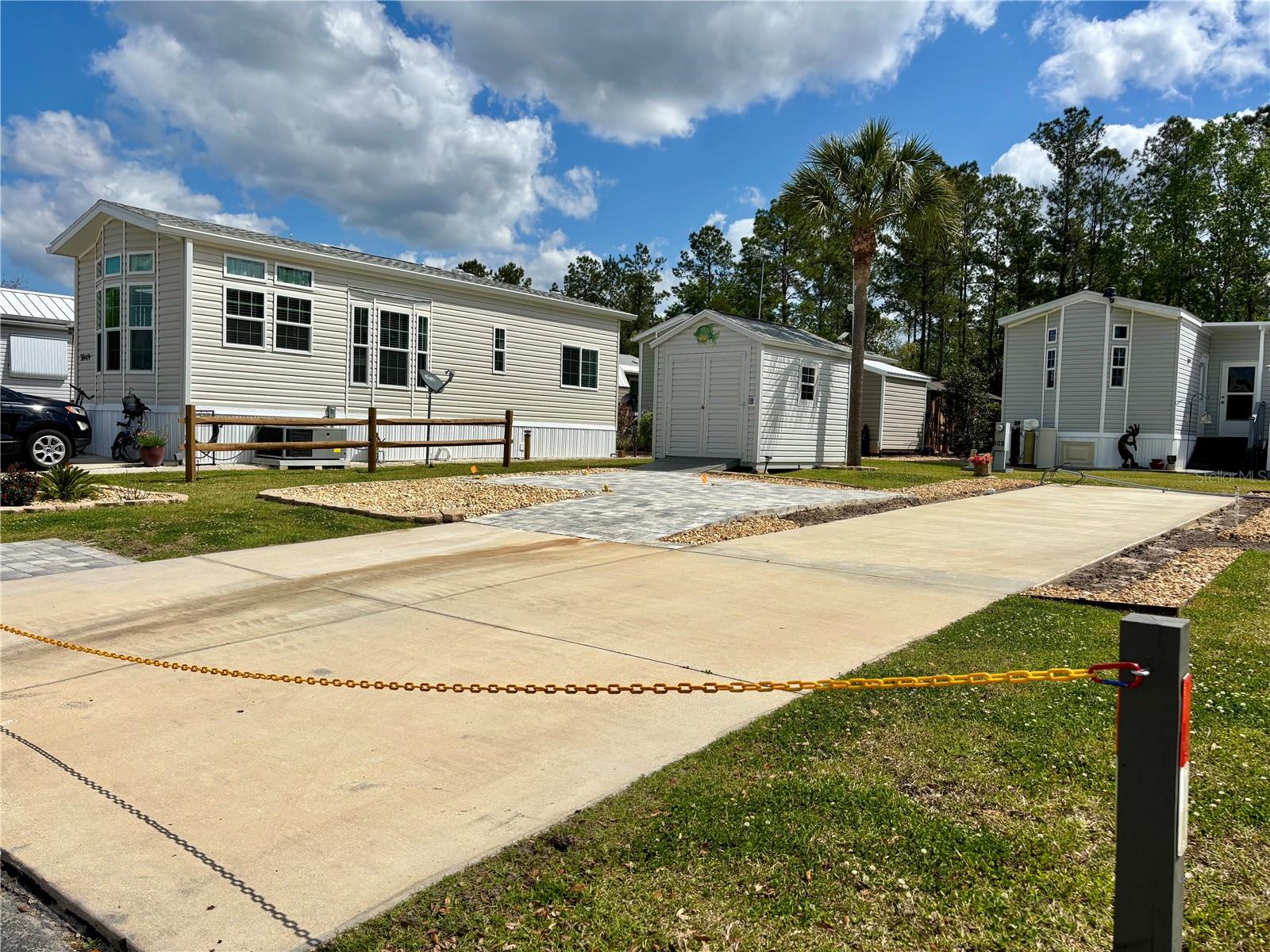 Wilderness RV Park!! Own the Land!! This beautiful, upgraded lot situated in the Town Park features a new 8' x 12' shed with electricity and custom pavers with a 14'x18' patio area that is perfect for a pergola and enjoying the Florida climate. This lot has a large concrete pad that is ideal for parking your RV or adding a park model home. In addition, there is also room for parking 2 cars and a 5'x8' paver golf cart parking pad. The Wilderness RV Park offers a wealth of amenities, including a fitness center, pool, shuffleboard courts, Greenway hiking trails, and access to the Ocklawaha River. Also, the Town Park has its own clubhouse and heated pool and hot tub. Located just outside Ocala, it's a short drive to the renowned Silver Springs State Park, various shopping centers, restaurants, healthcare facilities, and the historic downtown area. Ormond Beach is also just an hour away. Ownership of the land is deeded, and the HOA fee covers road maintenance, water, sewer, trash, lawn care, gate security, pool, and other recreational amenities.