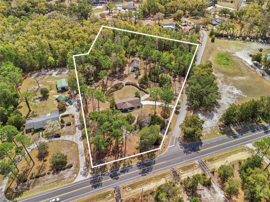 Nestled on a picture-perfect 4.53-acre parcel, this recently restored home is ready to make its debut on the market! Lovingly cared for over the years and now thoughtfully updated, this property blends comfort, style, and privacy. Inside, the home showcases gorgeous warm-tone luxury vinyl plank flooring that flows throughout the main living areas. The beautifully updated kitchen features new cabinetry, quartz countertops, a trendy backsplash, and modern finishes, all opening to the inviting family room where a wood-burning fireplace serves as a cozy focal point. A separate living room provides the extra space every family appreciates. The owner’s suite bathroom is a standout, offering a stunning oversized walk-in shower and an updated vanity that brings a luxury feel to the space. Step outside and you’ll find a property designed for both function and relaxation. The workshop is a gem of its own, providing plenty of room for hobbies, projects, or storage, while the covered area is ideal for gatherings or keeping equipment protected. The back portion of the property offers peaceful privacy and serene surroundings, complete with a firepit area where you can unwind and enjoy the quiet beauty of nature. The location is incredibly convenient—just minutes from town and I-75. Additional updates include new double-paned windows throughout, HVAC (2021), and a new garage door and opener (2026). This property offers the perfect blend of updated living, usable acreage, and privacy.