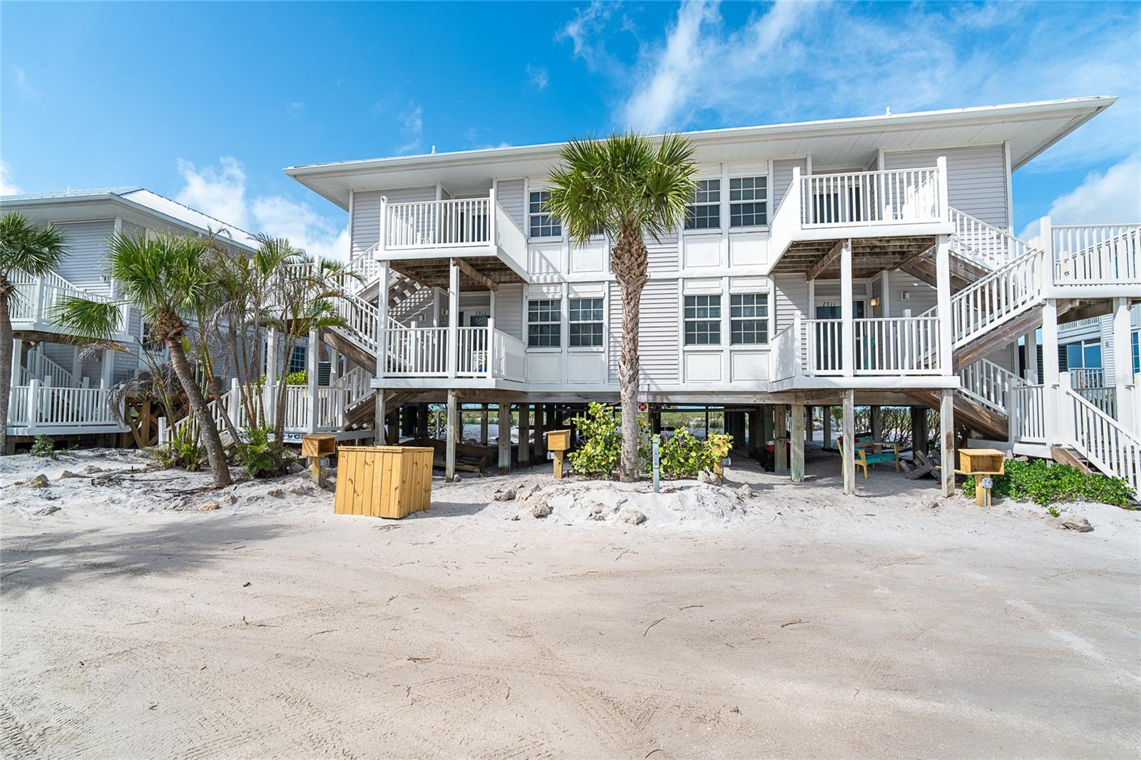 Located on the Gulf between Ft. Myers and Sarasota is this amazing island! Just a car ferry ride across the intercoastal takes you where there is access to 7 miles of pristine Florida beach. Enjoy the spectacular sunsets Southwest Florida boasts about! This villa has an unobstructed view of the water. Relax on the lovely screened in porch and watch for the green flash. This 2-bedroom villa is move in ready. Neutral tile throughout, coastal decorated and ready for its next owner to enjoy. Be a part of the resort's vibrant tennis and pickle ball community, attend the fitness classes, or simple start your shell collections. The primary suite has a king size bed, ensuite with double sink and walk in shower. It also features sliding doors to the porch, go ahead open them and up and listen to the waves. Laundry room inside and a guest room for your visiting friends or family. Looking for a beach villa on a tropical island, it just doesn't get any better!