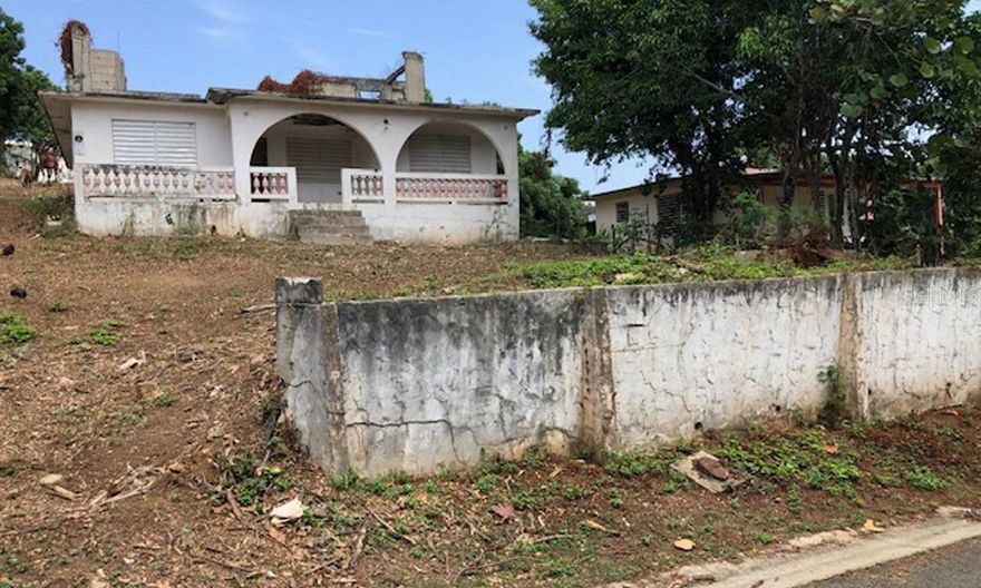 Great Location! Residential Lot of approximately 1/3 of an acre has an Unregistered Title and is zoned for Residential Use. HAS ELECTRIC AND WATER ACCOUNTS paid to date!!

ot slopes up and away from street affording water views from the top of the lot. A 2 story build would provide great views!

In an area of Bravos with some exceptional properties…10 minute walk to La Chatta beach! Up and over a hill to the ferry and Isabel II.

Quiet …except for the roosters. Oh, that’s everywhere on an island! Part of our charm.

Great news, in that since there was a home….there are active water and electric accounts!!! Good VALUE in that!!!!

Title can be acquired from the Municipality by the Buyer. Shell Structure as is.