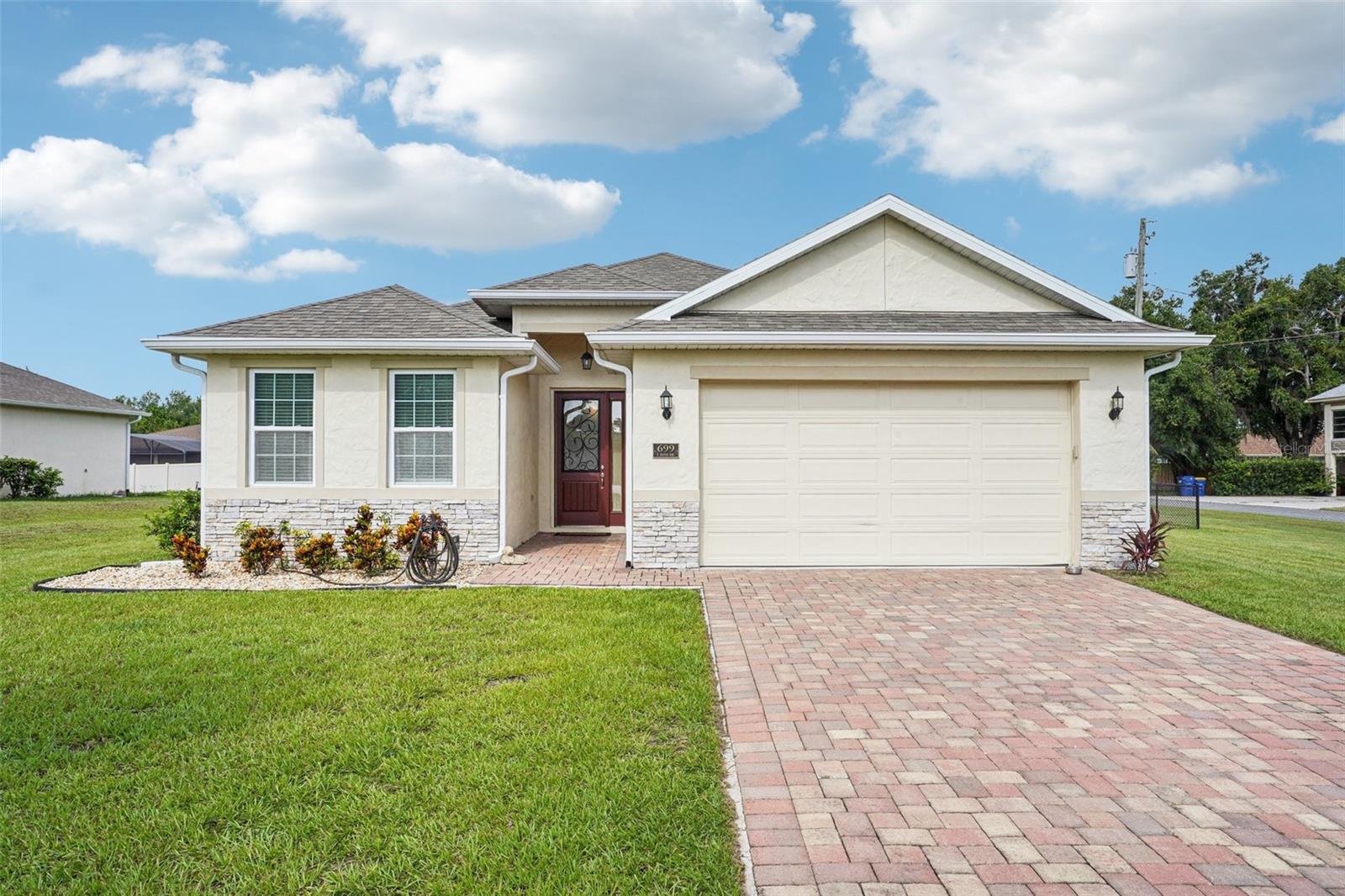 This nearly new, one-owner home offers peaceful living in the heart of Howey in the Hills. Built in 2019 and meticulously maintained, this 3-bedroom, 2-bath home features a bright, open floor plan with vaulted ceilings in the main living area that create a spacious and airy feel. The kitchen, living, and dining areas flow seamlessly—perfect for both everyday living and entertaining.
The oversized garage has been extended 4 feet to comfortably fit larger vehicles or a small boat—an added bonus with the community boat ramp just a few blocks away. Sitting on a fully fenced corner lot over a quarter acre in size, there’s plenty of room to enjoy outdoor living, garden, park your boat or RV, or let the pets run free.
Located in a quiet, established neighborhood with no HOA, this home is ideal for anyone looking to enjoy a slower pace without sacrificing convenience. You’re just minutes from the Florida Turnpike and a short drive to the community boat ramp with access to the Harris Chain of Lakes. This home combines comfort, functionality, and a great location—all within easy reach of everything Central Florida has to offer.
Whether you're downsizing, relocating, or searching for your first home, this one checks all the boxes.