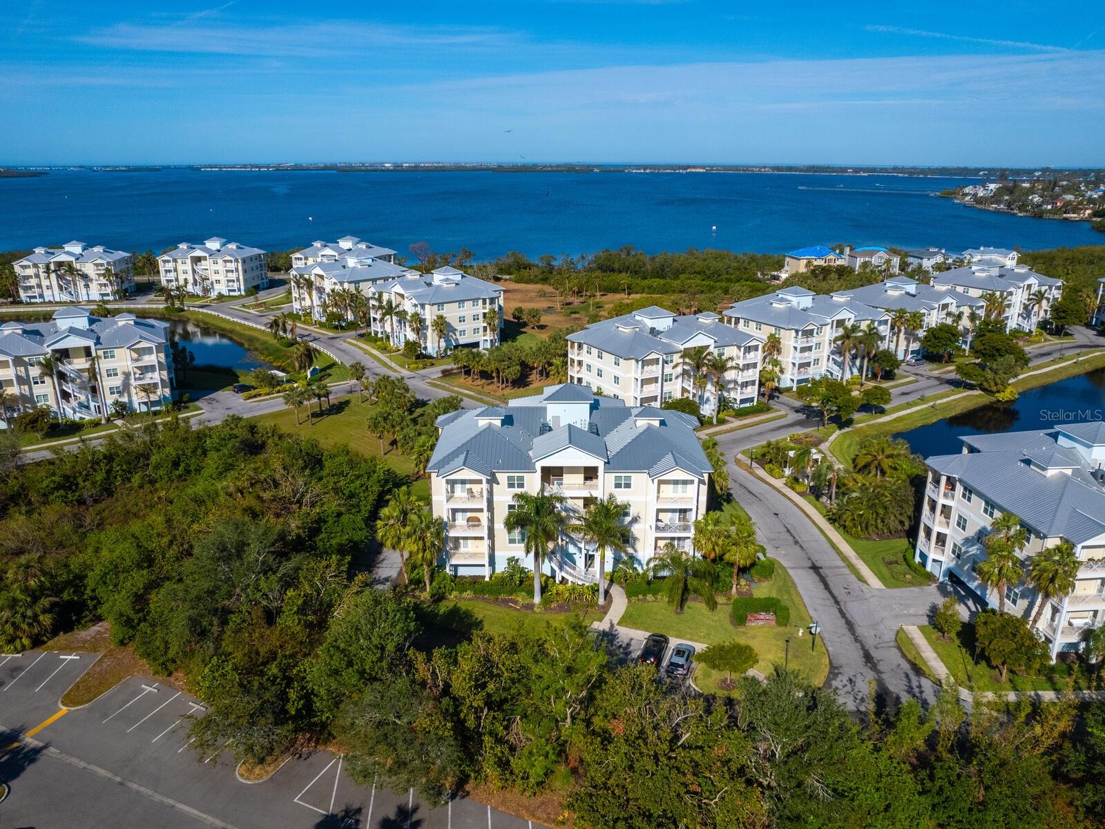 Welcome to Palma Sola Bay Club, your gateway to outdoor bliss! Discover a rare gem for outdoor enthusiasts and luxury seekers alike. Within a serene 30-acre nature preserve, this exclusive condominium community offers resort-style living at its finest. A coastal retreat to call home. This private end-unit condominium boasts 1,650 square feet of air-conditioned living space, complemented by a spacious terrace overlooking lush park-like views and one of three picturesque, stocked ponds. High ceilings and an open floor plan create an inviting atmosphere, ideal for entertaining or relaxing after a day of adventure. Prime location for an active lifestyle. Just minutes from Bradenton Beach, Anna Maria Island, and the seafood delicacies and shopping scene of Cortez, your new home is surrounded by natural beauty and endless activities. Explore the trails at Robinson Nature Preserve, enjoy outdoor fun at GT Bray Park, or immerse yourself in history at DeSoto National Memorial Park. Exceptional features and amenities, construction and updates. Freestanding concrete block and steel construction, elevator access and a new metal roof in 2024. Parking and storage with two designated under-building parking spaces, a 10-foot-by-5-foot storage cage, plus kayak and bicycle storage. Chef’s kitchen with custom tile backsplash, granite countertops, stainless steel appliances and ample custom cabinetry. Primary suite oasis. A spacious retreat with a walk-in and built-in closet, luxurious soaking tub, large shower, dual vanities and private toilet room. Additional comforts with a generously sized guest bedroom, oversized laundry room including a side-by-side washer and dryer, and window blinds throughout. Resort-style amenities. Enjoy your new friends while grilling your dinner around a heated pool, two-story clubhouse, fitness center, billiards, library, outdoor grilling stations, fire pit, putting green, bocce ball court, dog park and a kayak launch for exploring Palma Sola Bay. Community perks with low HOA fees of $1,060 a month, you’ll benefit from comprehensive services, including building insurance, high-speed internet, Blue Stream TV, exterior maintenance, pest control, recreational facilities and more. Pet-friendly and flexible leasing. Palma Sola Bay Club welcomes pets and offers leasing opportunities, making it ideal for snowbirds, year-round residents or investors. Live where luxury meets nature and adventure. Schedule your private tour today and experience the Palma Sola Bay Club lifestyle.
