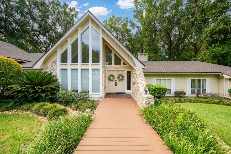 Welcome home to this exquisite 4-bedroom, 2.5-bathroom pool home with a sunroom, tucked away in the serene and highly sought-after Fox Grove neighborhood—nestled behind Brywood.** Perfectly positioned at the end of a quiet, tree-lined cul-de-sac, this stunning residence sits on a spacious lot surrounded by other beautiful, established homes, offering a wooded backdrop that enhances both privacy and natural beauty. A circular driveway leads to the elegant entrance, where the home’s signature stonework makes a striking first impression and continues inside to the inviting foyer. Step into the soaring living room featuring vaulted ceilings, a dramatic floor-to-ceiling stone fireplace, and expansive views of the lush property beyond. The luxurious primary suite is a true retreat—complete with a private fireplace in the sitting area, sliding doors opening to the back patio, two generous walk-in closets, and a spa-like bathroom with a jacuzzi tub. The spacious living room offers multiple sitting areas and a full wet bar that can be seamlessly tucked away, making it ideal for both entertaining and everyday living. Outside, relax or entertain by the sparkling pool surrounded by peaceful wooded views or on the durable Trex decking open patio, all while knowing the home is protected with a whole home generator. This home offers a perfect balance of tranquility and convenience, with unbeatable proximity to UF, UF Health, Fresh Market, Publix, Thornebrook Village, top-rated schools, parks, and shopping centers. Experience refined living in one of Gainesville’s most desirable neighborhoods—where natural beauty meets everyday luxury.