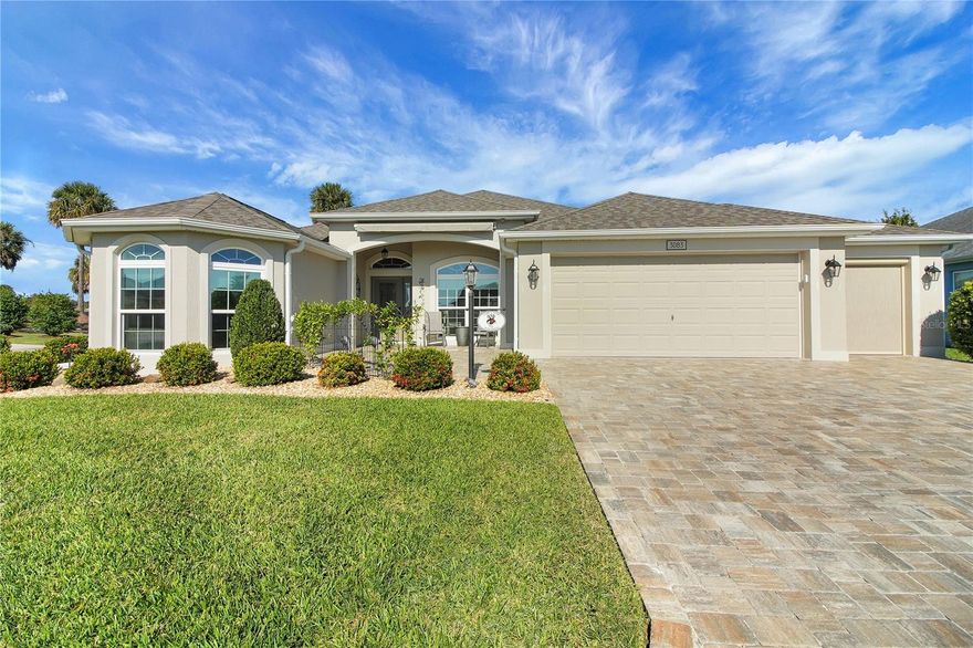 Wow... This fully upgraded Gardenia Model in the Village of Fenney offers three bedrooms, two baths, an oversized two-car garage plus a golf cart garage, and is truly better than new. From the moment you arrive, you’ll notice the paver driveway and expanded front porch with pavers and an awning, setting the tone for the quality throughout. Inside, the foyer opens to high ceilings, crown molding, and 5 ½-inch baseboards that add elegance to every room. The kitchen is appointed with quartz countertops, stainless steel appliances, abundant cabinetry with pull-outs, and both a breakfast bar and dinette area. Porcelain tile laid diagonally flows through the main living spaces, while the bedrooms feature luxury vinyl plank flooring. The inviting Florida room provides expanded living space with privacy and a small fenced area ideal for pets, grilling, or entertaining. The spacious primary suite includes a tray ceiling, dual closets, and an ensuite with dual vanities, a Roman shower, and a private water closet. The split floor plan ensures privacy with a second bedroom measuring 11 by 15 feet, complete with a tray ceiling and closet, and a third bedroom with closet measuring 11 by 11 feet, along with a guest bath featuring a shower/tub combination. Additional highlights include a nook area leading to the inside laundry room, which connects to the oversized garage measuring 21’6” by 28’. The garage offers painted concrete flooring, pull-down attic access, a water softener, an electric garage screen for the golf cart bay, and extra cabinetry for storage. Furnishings are available separately, making this home a turnkey opportunity that combines modern upgrades, thoughtful design, and exceptional value. BONUS...The pool & mailboxes are less than 1 mile away!