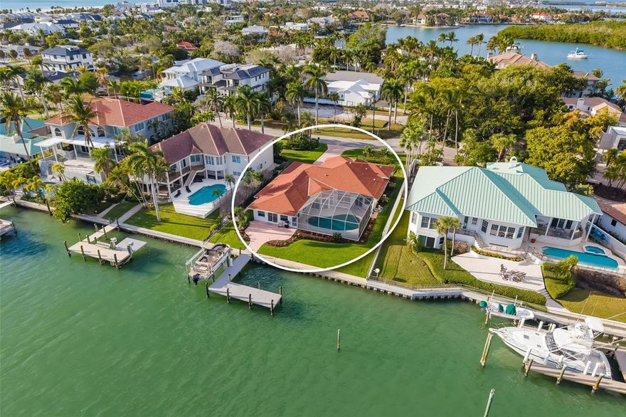Discover a rare Lido Key sanctuary offering direct, bridge-free boating to the Gulf of Mexico and a private waterfront pool. Perfectly positioned along the bay and sold fully furnished, this home delivers effortless luxury with immediate access to open water, serene outdoor living, and one of Sarasota’s most desirable island lifestyles.

Designed to embrace its waterfront setting, the expansive living areas open seamlessly to the outdoors. Six sets of sliding glass doors frame tranquil water views and create a fluid connection to the screened-in waterfront heated pool and expansive paver deck, ideal for both entertaining and everyday relaxation. From poolside lounging to sunset evenings by the water, the outdoor spaces flow directly to the private expanded dock with lift, complete with power and water, allowing you to reach the Intracoastal and Gulf of Mexico within minutes—with no bridges to navigate. You’ll love the peacefulness of the canal right at your doorstep. 

Inside everything has been renovated and updated in 2025! The kitchen is both elegant and functional, featuring stainless steel appliances, a built-in microwave, floating shelves, generous cabinetry, and a thoughtfully placed pantry adjacent to the laundry room, which includes a utility sink. Porcelain tile flooring runs consistently throughout the entire home, enhancing the clean, sophisticated aesthetic and open feel of the living spaces.

The private living quarters are thoughtfully arranged for comfort and flexibility. A bedroom located at the front of the home offers an ideal guest retreat, while a beautifully designed office or den welcomes you upon entry, highlighted by three bay windows that fill the space with natural light. This office/den is enclosed with French doors, making it an ideal flex space for working from home, a media room, or additional entertaining. The primary suite is a true sanctuary, complete with custom his-and-her closets and a spa-inspired bathroom featuring floor-to-ceiling tile, a glass-enclosed shower, and plantation shutters. A conveniently located half bath enhances functionality for guests and gatherings.

Outside your door, enjoy the quiet, walkable streets of Lido Key, offering a peaceful residential atmosphere with minimal traffic. Explore nearby nature trails and kayak launches, stroll to St. Armands Circle, or take a short drive over the Ringling Bridge to Downtown Sarasota for world-class cultural offerings, fine dining, and shopping. The home is zoned for Southside Elementary School, Booker Middle School, and Sarasota High School, and SRQ Airport is just minutes away, making travel effortless.

With its luxury waterfront setting, private pool, direct Gulf boating access, and full furnishings included, this Lido Key residence offers a rare opportunity to own a timeless coastal retreat where every detail supports a lifestyle of ease, elegance, and exclusivity.

Schedule your private showing and experience this exceptional waterfront offering firsthand.
