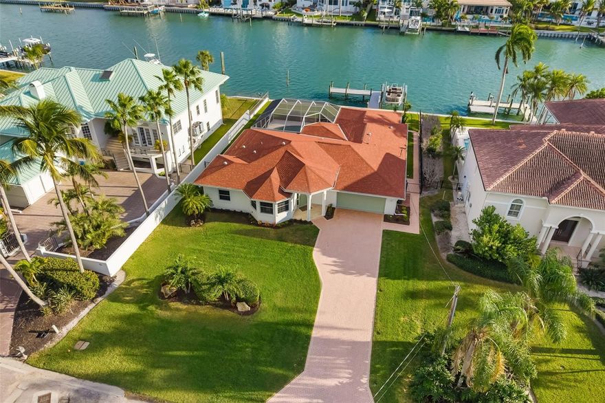 Experience the ultimate in coastal luxury with this exceptional waterfront residence on Lido Key. Perfectly positioned along a wide, private deep-water canal, this beautifully renovated 3-bedroom, 3.5-bath home offers direct, bridge-free boating access to the Intracoastal Waterway and the Gulf of Mexico—an extraordinary feature for boating enthusiasts.
Just two blocks from pristine Lido Beach and within walking distance to the vibrant shops and restaurants of St. Armands Circle, this home combines an unbeatable location with a serene, private setting.
Designed to maximize its stunning waterfront surroundings, the home features expansive living spaces with six sets of sliding glass doors that seamlessly blend indoor and outdoor living. Step outside to a screened-in, south-facing heated pool and spacious paver deck—ideal for entertaining or simply relaxing while enjoying tranquil canal views. The private dock 2024 is fully equipped with a lift, power, and water, making it effortless to get out on the water at a moment’s notice. Lift can take 12,000 pounds. 
Inside, the home has been completely renovated in 2025 with a focus on modern elegance and functionality. The kitchen showcases stainless steel appliances, a built-in microwave, floating shelves, and ample cabinetry, along with a conveniently located pantry adjacent to the laundry room with utility sink. Porcelain tile flooring runs throughout, enhancing the home’s clean, sophisticated aesthetic.
A thoughtfully designed layout offers both comfort and flexibility. A front-facing guest suite provides privacy for visitors, while a light-filled office or den—framed by three bay windows and enclosed with French doors—serves as an ideal workspace or additional living area. The primary suite is a private retreat featuring custom dual closets and a spa-inspired bathroom with floor-to-ceiling tile, glass-enclosed shower, and plantation shutters. A stylish half bath adds convenience for guests. Rental Projections avail. Investment Opportunity.
Offered fully furnished, this home is truly move-in ready and designed for effortless coastal living. Enjoy quiet, walkable streets, nearby nature trails, and easy access to downtown Sarasota via the Ringling Bridge, where world-class dining, arts, and culture await.
This is a rare opportunity to own a turnkey waterfront sanctuary in one of Sarasota’s most coveted island communities—where luxury, location, and lifestyle come together seamlessly. Walk to Lido Beach and catch a Sunset Or take the boat!