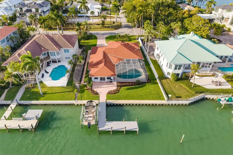 Boater's Delight on Lido Key. Beautiful Home with 3 Bedrooms, 3.5 Baths on a Beautiful, Wide, Private, Deep Water Canal with a Dock with Electric and a Partial View of the Bay. No Bridges to the Bay. Rear of Home has a Southern Exposure with a Lovely Heated Pool and an Enchanting Covered Patio for Entertaining with Serene Water Views. 
Only Two Blocks from Beautiful Lido Beach. Walk to Trendy St. Armands Circle to Shop and Dine. Discover a rare Lido Key sanctuary offering direct, bridge-free boating to the Gulf of Mexico and a private waterfront pool. Perfectly positioned along the bay and sold fully furnished, this home delivers effortless luxury with immediate access to open water, serene outdoor living, and one of Sarasota’s most desirable island lifestyles.

Designed to embrace its waterfront setting, the expansive living areas open seamlessly to the outdoors. Six sets of sliding glass doors frame tranquil water views and create a fluid connection to the screened-in waterfront heated pool and expansive paver deck, ideal for both entertaining and everyday relaxation. From poolside lounging to sunset evenings by the water, the outdoor spaces flow directly to the private expanded dock with lift, complete with power and water, allowing you to reach the Intracoastal and Gulf of Mexico within minutes—with no bridges to navigate. You’ll love the peacefulness of the canal right at your doorstep. 

Inside everything has been renovated and updated in 2025! The kitchen is both elegant and functional, featuring stainless steel appliances, a built-in microwave, floating shelves, generous cabinetry, and a thoughtfully placed pantry adjacent to the laundry room, which includes a utility sink. Porcelain tile flooring runs consistently throughout the entire home, enhancing the clean, sophisticated aesthetic and open feel of the living spaces.

The private living quarters are thoughtfully arranged for comfort and flexibility. A bedroom located at the front of the home offers an ideal guest retreat, while a beautifully designed office or den welcomes you upon entry, highlighted by three bay windows that fill the space with natural light. This office/den is enclosed with French doors, making it an ideal flex space for working from home, a media room, or additional entertaining. The primary suite is a true sanctuary, complete with custom his-and-her closets and a spa-inspired bathroom featuring floor-to-ceiling tile, a glass-enclosed shower, and plantation shutters. A conveniently located half bath enhances functionality for guests and gatherings.

Outside your door, enjoy the quiet, walkable streets of Lido Key, offering a peaceful residential atmosphere. Explore nearby nature trails and kayak launches, stroll to St. Armands Circle, or take a short drive over the Ringling Bridge to Downtown Sarasota for world-class cultural offerings, fine dining, and shopping. 
With its luxury waterfront setting, private pool, direct Gulf boating access, and full furnishings included, this Lido Key residence offers a rare opportunity to own a timeless coastal retreat where every detail supports a lifestyle of ease, elegance, and exclusivity.

Schedule your private showing and experience this exceptional waterfront offering firsthand.