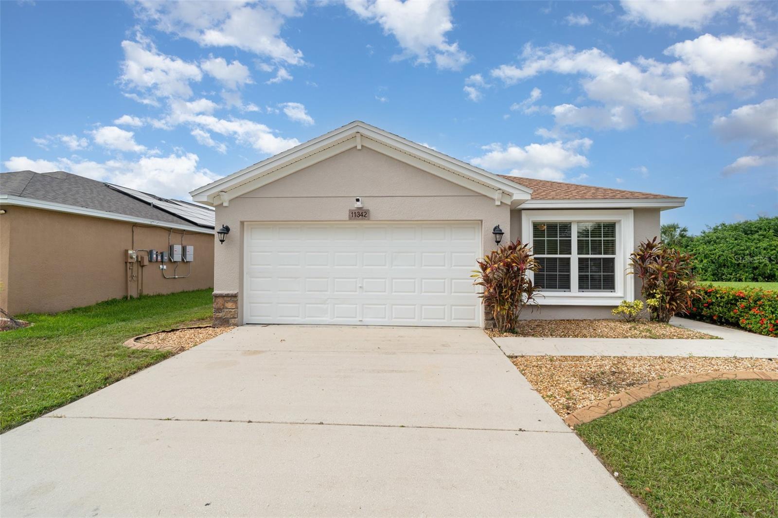 Move-in ready! This stunning 4-bedroom, 2-bath home was built in 2015 with over 1,600 sq ft of comfortable living space and a 2-car garage. Perfectly situated right on the lake, it offers breathtaking lake views, privacy, and no neighbors on one side. Freshly painted inside (with transferable guarantee), this home also features a new roof , bringing peace of mind and lasting value. A smart alarm system with integrated cameras, plus remote thermostat and front-door controls, adds modern convenience.