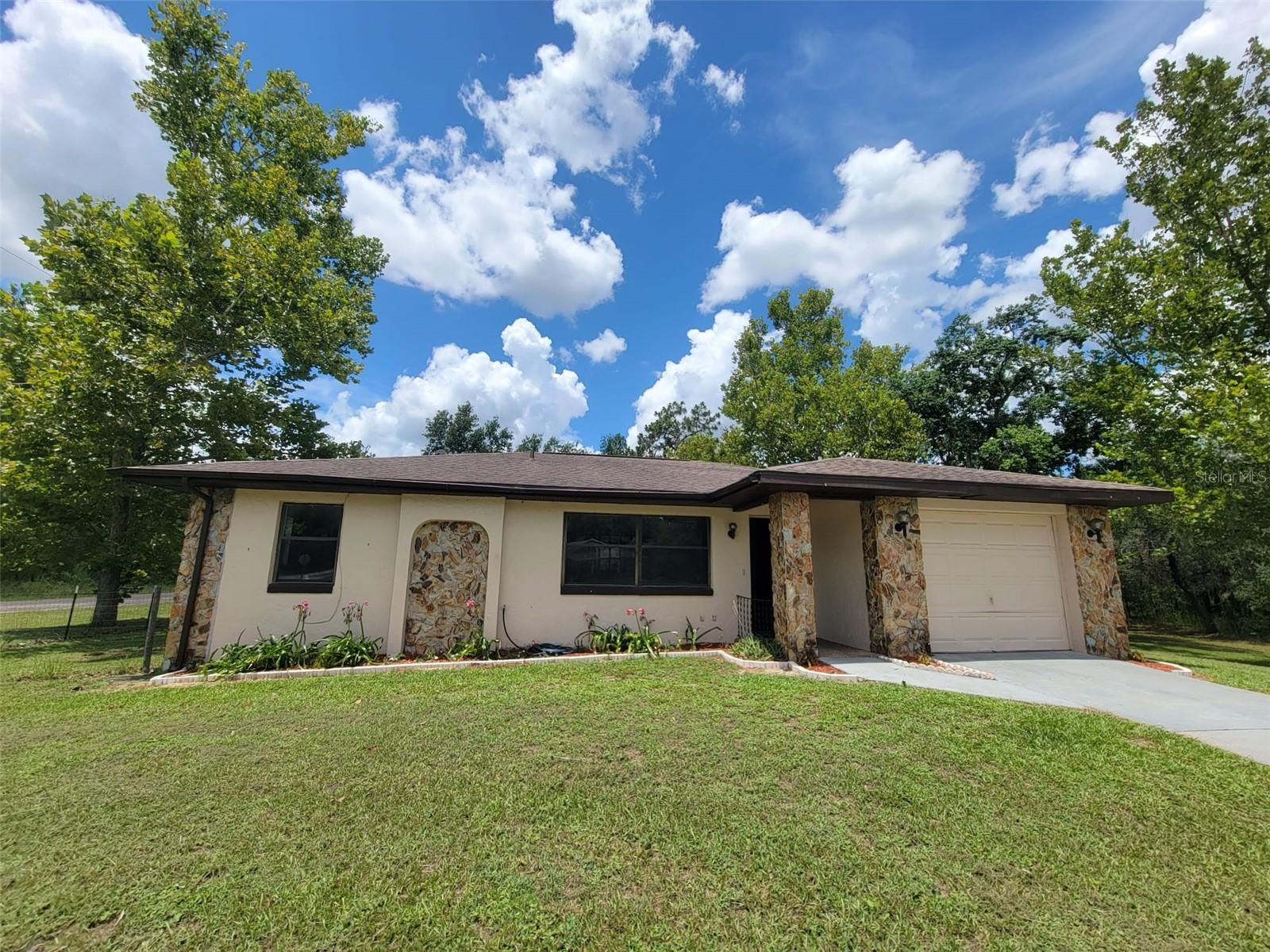 Back on Market!, Fresh, affordable, and move-in ready! This charming 3-bedroom, 2-bath home sits on a spacious .32 acre corner lot in Citrus Springs, offering privacy, beautiful trees, and no neighbors directly beside or behind you. Inside, you'll find brand new luxury vinyl plank flooring throughout, fresh paint, and updated lighting fixtures in the main living areas. The layout is bright and functional, with a cozy dining area, large living room, and access to a brick patio in the fully fenced backyard—perfect for relaxing or entertaining under the mature crepe myrtle and sycamore trees. While the kitchen & bathrooms are vintage style, everything is in good working order, making this a great opportunity to move in now and update over time to your taste. Located in the deed-restricted Citrus Springs community—with no HOA fees—residents enjoy access to the Citrus Springs Golf & Country Club, tennis courts, parks, a community center, library, and excellent schools within the community. Nature lovers will appreciate the Withlacoochee State Trail nearby, along with proximity to Rainbow Springs, the Gulf of Mexico, and the expansive Halpata Tastanaki Nature Preserve. Vacant and easy to show — priced to sell quickly!