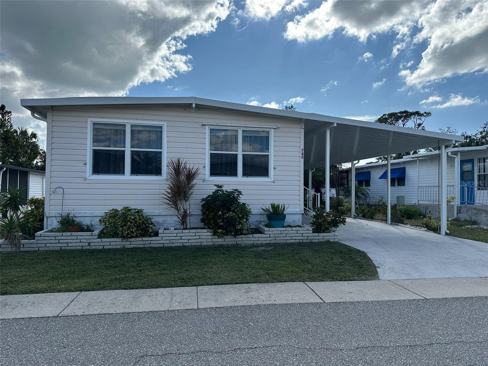This beautiful two bedroom, two bathroom unit is located in Japanese Gardens. Less than 2 miles from Manasota Beach, Japanese Gardens is a popular 55+ community with many activities and amenities. This home sits on the perimeter of the community in the dog friendly section of the park. No neighbors behind you! The home features new luxury plank vinyl flooring throughout with plywood subfloors, new vapor barrier, new roof over, new lanai roof, new carport and carport tie downs, and new lighting fixtures. It is beautiful and move in ready!