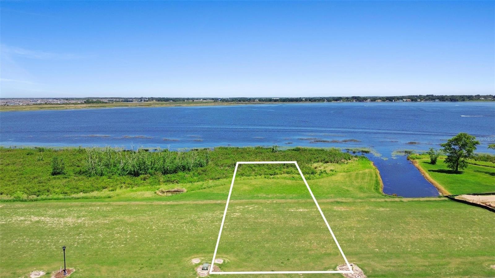Embrace the opportunity to own this cleared, leveled vacant lot with an open view of beautiful Lake Alfred, offering extra privacy and endless potential—no time restrictions to build! Located in the upscale Water Ridge community, enjoy resort-style living with top-notch amenities including 3 pools, 2 boat ramps, pickleball and tennis courts, basketball, a state-of-the-art fitness center with sauna and lockers, fishing piers, plus boat and jet ski storage. Just 40 minutes from Disney and 25 minutes from Legoland, this lot is perfectly positioned in a rapidly growing area full of exciting new developments. Don’t miss your chance to build your dream lifestyle in a truly exceptional setting!