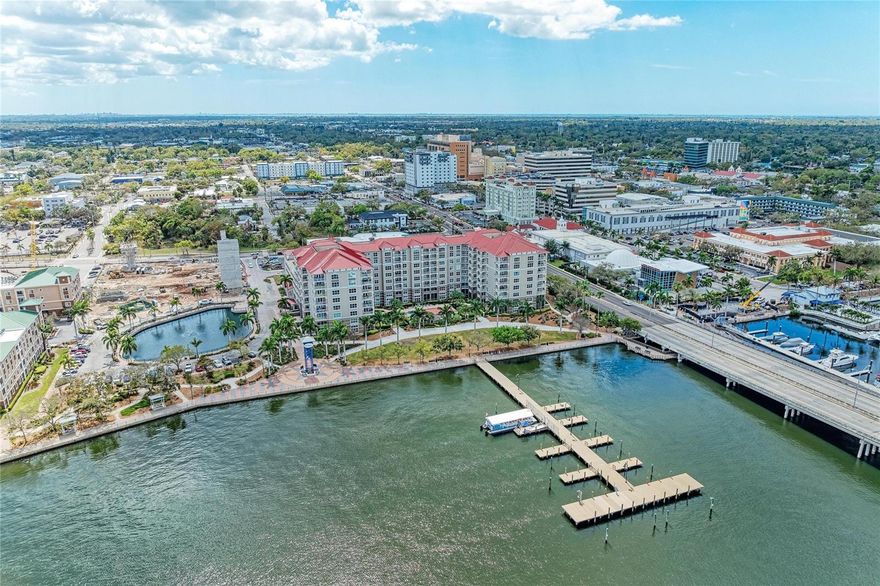 Imagine evenings on your private balcony with peaceful pool views and a sunset glow over the Manatee River. Set in a beautiful park-like setting along the scenic Riverwalk, this 2-bed, 2-bath, 1,514-SF residence offers a rare blend of waterfront living and walkable access to downtown Bradenton’s restaurants, shops, cultural venues, and marinas. The Anna Maria Island Ferry docks just outside the community, giving you a scenic, care-free route to the island’s beaches.  Inside, an open layout seamlessly connects the  kitchen (with granite counters) to the dining and living areas. The spacious primary suite features a walk-in closet and a spa-like bath with a garden tub, shower, double sink vanity, linen closet, and private water closet with a Toto bidet seat. A split floor plan places the guest bedroom and bath on the opposite side for added privacy. Recent upgrades include impact windows, newer carpeting in the bedrooms, and  A/C unit replaced 11/2024.  River Dance residents enjoy secured entry, on-site management, and an impressive list of amenities: heated pool and spa, tennis and pickleball courts, basketball court, theatre room, 6-hole putting green, club and game rooms, fitness center with rooftop jogging track, business center with conference room, and two rentable guest suites. Waterfront walking paths  and river views enhance your Downtown lifestyle.