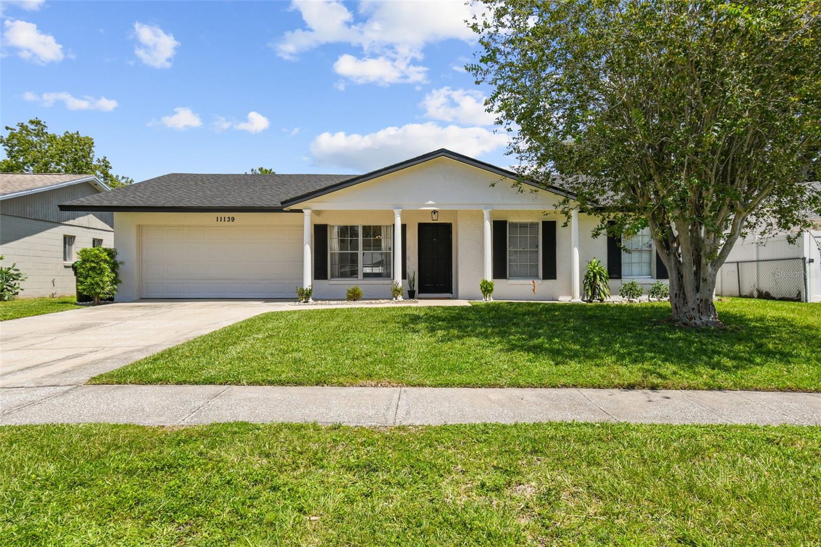 Welcome to this light-filled and spacious single-story home in the sought after Sky Lake South community! Thoughtfully updated and ready for new owners, this property offers the perfect blend of comfort, style, and convenience. Major Updates Already Done for You Include: NEW ROOF (June 2025), Fresh Interior and Exterior Paint in a neutral palette, NEW KITCHEN with brand-new cabinets, sink, faucet and sleek quartz countertops, Updated Bathrooms with NEW BATH VANITIES and faucets. Easy care vinyl flooring in all bedrooms, no carpet anywhere! Ceramic tile throughout the main areas and hallway. Step into the impressive great room where soaring ceilings with accent beams create an open, airy feel. The adjoining dining area and den offer flexible spaces, perfect for entertaining or creating a cozy retreat.Then step outside to your expansive 28x10 screened and covered patio, ideal for relaxing, dining al fresco, or entertaining year-round. The fully fenced backyard has plenty of room for a pool, pets, or play. There's an indoor laundry room too! Stow your cars, lawn equipment or toys in the two car garage with automatic door opener. Sky Lake South residents also enjoy community tennis and basketball courts and a playground. This location is hard to beat! Only minutes from major highways (417, I-4, Turnpike), theme parks including Universal Orlando’s new Epic Universe, shopping at The Florida Mall, and everyday conveniences like Costco just down the road. Homes with these updates and features make everyday living more enjoyable.