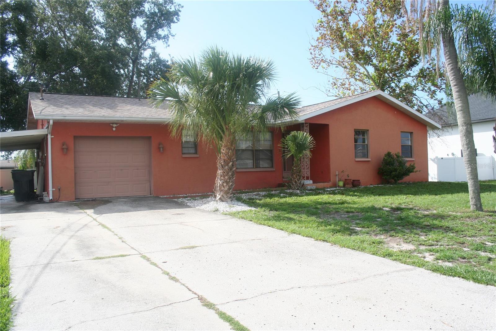 Welcome Home! This custom, move-in ready 3-bedroom, 2-bathroom residence includes a versatile 324 sq. ft. bonus room that can easily serve as a spacious office, playroom, or even a 4th bedroom. With 1,476 sq. ft. of comfortable living space—priced at just $196.14 per sq. ft.—plus an attached garage and carport, this home delivers incredible value at under $300K. Set on an elevated lot with no hurricane damage from the past two storms, this property offers peace of mind along with a long list of upgrades: a brand-new $16,500 roof, new electric panel and breakers, a new 40-gallon water heater, a 2-year-old AC system in excellent condition, no cast iron plumbing, freshly installed LED kitchen lighting, matching porcelain tile flooring throughout, a spacious walk-in shower in the front bathroom, and ample pantry and storage space. Outside, enjoy a generous backyard shaded by mature trees, with plenty of room to customize fencing and add front gates for secure, fully enclosed privacy. With no HOA or CDD fees, this home is a smart choice whether you’re a first-time buyer or simply looking for a move with lasting value. Comfort, durability, and thoughtful upgrades make this home a true gem—don’t miss your chance to see it before it’s gone!