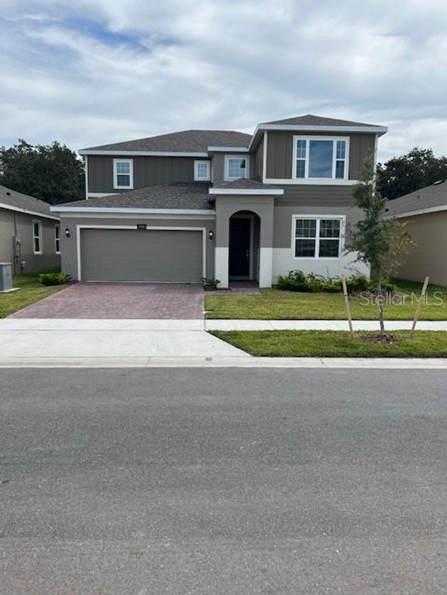 Special Financing Rate and Closing Cost Incentive included. This home can close this year! Ready for Quick Move-In, our popular Sutton plan offers a Double Master, featuring an additional master bedroom on the first floor with full bath and walk-in closet. This spacious and inviting floor plan offers distinct split bedrooms and a versatile Living Room positioned at the front entrance, perfect for use as a home office or a playroom. The generously proportioned Family Room overlooks rear covered Lanai and  provides picturesque views of the surrounding trees and woods, with Lake Alligator nestled just beyond.  The kitchen takes center stage, boasting 42” upgraded cabinets with crown molding, luxurious quartz countertops, stainless steel appliances, and an exquisite tile backsplash. The Primary Suite on 2nd Floor features luxurious bath with dual sinks thoughtfully situated within an adult-height vanity and framed by sleek, frameless glass shower doors.  This High Performance Home, incorporates intelligent home automation technology and energy-efficient features. The exterior includes Brick paver driveway and lead walk to the entrance.  Canals weave throughout the community connecting to a 3,400-acre lake and its chain of lakes. In addition to the natural beauty of the area, you can enjoy the resort-style zero-entry pool and splash pad or gather on the expansive sundeck with views of the community.  Hanover Lakes offers a convenient location in beautiful Osceola County, close to world-famous attractions such as Disney World Resort, Universal Studios Florida, and Sea World. The Atlantic Beaches are nearby as well, and expressways make Downtown Orlando’s sports and cultural venues easily accessible.