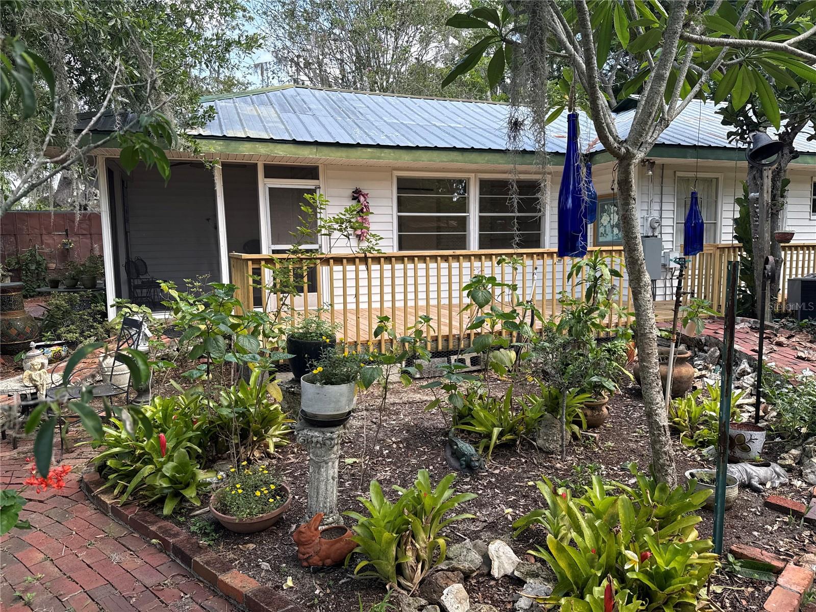This recently updated 2-bedroom, 2-bath home sits on over 0.3 acres and offers a rare combination of privacy and central location. Fully fenced with a tall metal privacy fence, the property features lush landscaping, four koi ponds, a potting shed, and winding brick paths throughout a peaceful garden setting.
The home includes a resurfaced pool (2025), a flagstone driveway, and a 3-car garage for plenty of parking and storage. Interior updates in 2025 include new luxury vinyl flooring, fresh paint, an upgraded electrical panel, and updated plumbing.
With a spacious layout and unique outdoor space, this property is ideal for anyone looking for a move-in-ready home with character and room to relax.