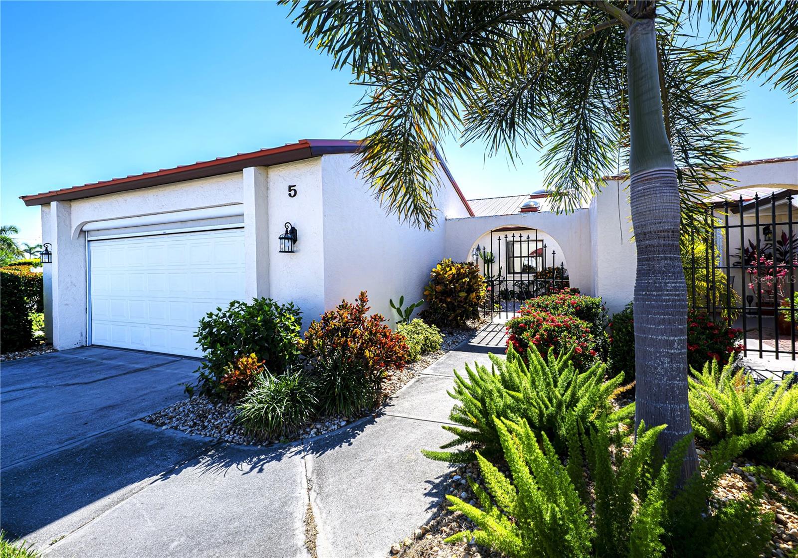 Looking for a Totally Remodeled Villa with New Roof and Skylights in 2022? Then look no more! As you walk through the private paver courtyard and enter the villa you will notice there is tile throughout. The floor plan is wide open. The beautiful updated kitchen with custom maple cabinets and granite counter-tops are the focal points enhanced by the cathedral ceiling and new skylights. There are pull-out drawers in the pantry as well as reverse osmosis. You will also notice the wet bar across from the kitchen. Plus there is all new plumbing throughout! Off of the spacious great room you will see the large Florida room/lanai overlooking the pond and gazebo-which is facing south and is a great place to entertain or just relax! It is enclosed with sliding windows, is all tile and has a separate a/c unit. There is a large storage closet at the end of the Florida room. Accordian shutters run the length of the room outside. The master bedroom has an elevated ceiling and also has access to the lanai. The master bath is beautiful with a jetted tub and a walk-in shower. There are dual sinks, custom wood cabinets and granite counters. On the other side of the house is the 2nd bedroom, large laundry room, and updated bath with wood cabinets, granite and a walk-in shower. Across the hall is the large 3rd bedroom which can also be used as an office or den. The villa has Hurricane protection-hurricane windows and hurricane sliders on lanai. updated lighting and oversized baseboards. Not to mention 8 ceiling fans! The double garage has a screen door. The complex offers 2 pools and a clubhouse. For convenience, this villa is located close to one of them! There is also a fishing pier and boating is allowed on the large lake- small boats only! See this gorgeous villa today! Just like a house but without the maintenance! You won't be disappointed!