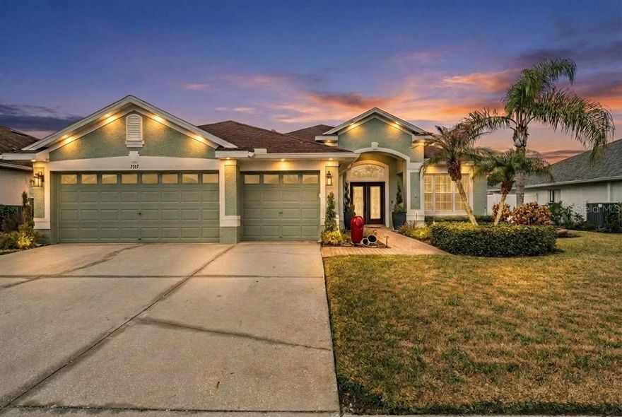 Talk about dream home! Come see this GORGEOUS four bed, three bath PLUS office home with THREE CAR GARAGE, SOLAR PANELS and SALTWATER POOL home in Valencia Gardens. To start lets mention location, it is located right across the street from the county park with a gated entrance. It's a short drive to Publix, I75, the outlets, mall and everything you need. That out the way, let's jump into the house. The house has been beautifully done and lit up tomatch the interior. As you pull up you notice the permanent exterior lights as well as the three car garage. Walking in you see a dining room with high ceilings that continue throughout the main living area as well as a beautiful office with glass sliding doors and wood floors. Continuing into the house you'll see a living room with a custom brick focal wall with tv mount and floating electric fireplace. The kitchen overlooks the living room and breakfast nook with its beautiful white cabinets and stainless steel appliances. You'll also notice through the Plantation Shutters (that are carried throughout the house) a large sliding door to your very own fenced in and screened in saltwater pool. The pool area has a bar top that is lit up to bring the vibes for any summer nights your hosting your friends. Back inside you have the master bedroom on the opposite side of the other bedrooms giving you the perfect split floorplan you've always wanted. The master bedroom has a high tray ceiling, with two closets, one walk-in and the other being a built-in. In the en-suite bath you'll find a jetted tub as well as a beautifully done shower with a rain shower head, and also dual vanities. The other side of the house has a bedroom with a bathroom both right off the pool, making it perfect for guests. The other two bedrooms are at the front and other side of the house. The three car garage is exactly what you've been looking for. Finally the house has solar panels that offset your electric bill! What more could you ask for!?