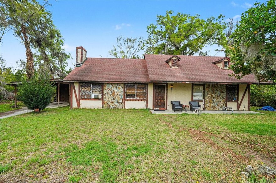 CASH BUYERS & INVESTORS! Bring your contractor and your vision to this original 1979 Dade City home, ideally situated on a queit cul-de-sac in the peaceful sought-after Hidden Park neighborhood. Offering 1,858 sq. ft. of heated living space and a 2,764 sq. ft. total footprint, this home sits on over a 1/4-acre lot, giving you tons of space to create your exact vision. ou are just minutes away from Historic Downtown Dade City, known for its charming brick streets, antique shopping, local dining, and the beautiful Withlacoochee River Park. Whether you are looking for a full flip or a retro-rehab, this home is packed with unique architectural character waiting to be restored. Original 1979 gems include a colossal floor-to-ceiling volcanic rock wood-burning fireplace, vaulted ceilings with an unexpected upstairs loft area, original terra-cotta entryway tile, and beautiful exposed interior brick. You will also find a kitchen featuring vintage lattice-front cabinetry, unique wood detailing and a large laundry room. Double doors take you to a huge indoor/outdoor bonus room with a door leading to an oversized storage shed. Another set of double doors leads you to a large covered lanai with connected electricity and a large backyard space. PLEASE NOTE: Ideal for a RENOVATION LOAN (like FHA 203k, HomeStyle, or CHOICERenovation) or a CASH BUYER looking to build equity; due to the age of this home, it is a candidate for a comprehensive systems refresh and updating to meet modern insurance standards. The property is being sold strictly AS-IS with the right to inspect. Bring your vision to this classic structure, which is ready for its next chapter of upgrades!
