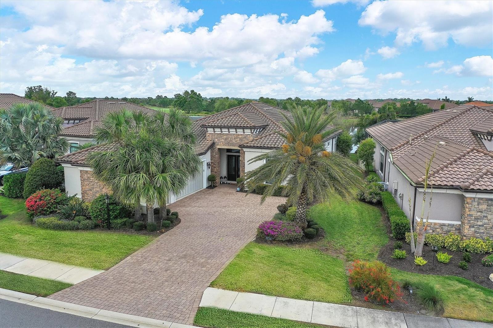 Enjoy vacation living without ever having to pack a suitcase! Esplanade in LWR is that community! Welcome to Taylor Morrison’s Luxury Lincoln Model! This home features 3 Bedroom, 3.5 Baths, a BONUS DEN/STUDY, and 3 car garage. Enjoy the sprawling lake and golf course views on your lanai that includes an outdoor summer kitchen and pool. This open floor plan home features 14' coffered ceilings and additional windows above the sliding doors allowing in much more natural light and enhances the lake views. The kitchen is equipped with GE Cafe stainless steel appliances, luxurious stone countertops, an extensive island, and a gas range. Both guest rooms come complete with closets complimented with built-ins and en suite bathrooms. The outdoor living space is as impressive as the interior with a summer kitchen complete with refrigerator, grill, and bar, a dining area, covered sitting area, and of course the pool. The Community features resort style living. The home comes with a full Country Club Membership. There are three on-site dining options, ranging from formal to an open-air style "Bahama Bar" and a Pizza Cafe. The Esplanade features a championship 18-hole golf course, 6 lighted HarTru tennis courts, and Pickleball courts. For all of the water lovers, the community has 2 pools, the main one is a resort style zero entry pool, and the other is a wellness pool with lanes for laps and room for water aerobics. You can also retreat to the nearby Hot Tub. Stop in at the "Koquina" spa for anything you need, from massages to body treatments, hair services, makeup services, spa packages, and MORE! Looking to meet your neighbors? Sign up to play a game of mahjongg, a paint class, wine nights, and special events! There is also bocce, billiards, and two dog parks. Lakewood Ranch features two downtowns and is right next to the University Town Center that has a ton of shopping, restaurants, and entertainment. Seller is a mortgage broker and is offering loan incentives for working with his company. Come see this house today! Check out the Matterport Link https://my.matterport.com/show/?m=P6fU1GgsgZf&mls=1