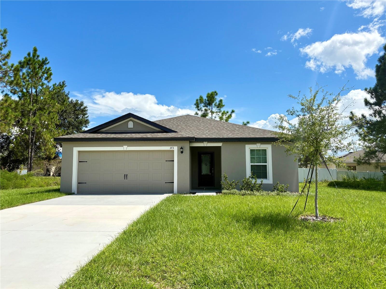 The Amelia by LGI Homes is a stunning single-story home located in the desirable community of Poinciana. This open-concept design offers 3 spacious bedrooms, 2 full baths, and an attached 2-car garage. Inside, the chef-ready kitchen features granite countertops, energy-efficient Whirlpool® appliances, wood cabinets with crown molding, and a large center island with a dedicated dining area. The private owner’s suite includes a walk-in closet and a full bath. Additional highlights include a utility room, covered back patio, and professionally landscaped front yard. Residents of Poinciana enjoy exceptional community amenities, including a baseball field, basketball court, playground, dog park, soccer field, swimming pool, volleyball court, and more. LGI Homes offers low to no down payment options, builder-paid closing costs, and thousands of dollars in upgrades already included. Quick move-in homes are available, and each home is backed by a structural warranty.
