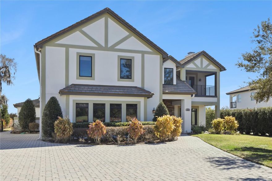 Fairway Prestige. Private Lake Serenity. Unmatched Lake Nona Luxury.

Setting the bar for luxury and elegance in one of the most coveted areas of highly desirable Lake Nona, this exceptional estate is located within the private gated community of North Shore on Lake Hart — where residents enjoy premier golfing and boating.

Spanning 5,165 square feet, this 5-bedroom, 7-bath residence offers the rare advantage of golf course views from the front and tranquil lake views from the rear. A long paver driveway and striking architectural elevation create impressive curb appeal. Inside, a grand entry with soaring ceilings and a dramatic curved staircase sets the tone for refined living. The formal living room with fireplace and elegant dining room provide sophisticated entertaining spaces, while expansive windows fill the home with natural light.

The custom chef’s kitchen features granite countertops, a large center island, stainless steel appliances, gas cooktop, decorative tile backsplash, under-cabinet lighting, and rich custom cabinetry. A window over the sink frames peaceful lake views. The kitchen flows seamlessly into the main living areas, while a mud room and oversized garage add everyday convenience. Upstairs, a spacious loft offers flexible living space ideal for a media room, lounge, or study.

The oversized primary suite is a private sanctuary with its own fireplace, dedicated his-and-hers closets, and exclusive access to a second-floor balcony overlooking Lake Hart — accessible only from the primary suite. The private second-floor balcony features durable wood-look composite decking, offering low-maintenance beauty while framing sweeping lake views. The spa-inspired ensuite bath features dual extended vanities, a garden soaking tub positioned beneath a large window capturing lake views, and an oversized glass-enclosed shower.

The backyard is a true waterfront retreat. A sparkling saltwater pool and expansive paver deck overlook the lake, framed by a majestic oak draped in Spanish moss. A custom-built treehouse nestled within its branches adds a rare and charming feature. Fully fenced and thoughtfully designed, this outdoor space offers both unforgettable entertaining and peaceful living.

Recent upgrades include exterior paint (2025), water heater (2025), A/C (2023), pool pump (2023), and two whole-home Sycom surge protectors.

Residents enjoy access to North Shore Golf Club’s 18-hole course, along with a community pool, tennis and basketball courts, baseball field, playground, fitness center, and community boat dock. Conveniently located near top-rated schools, SR-417, Lake Nona Medical City, Orlando International Airport, shopping, and dining.

This is more than a home — it is a lifestyle defined by elegance, recreation, and exclusivity.

Call today to schedule your private showing.