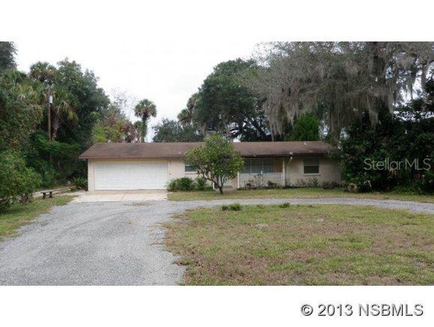 This is a one-of-a-kind find. Very deceiving from front..must see inside of this spacious home completely remodeled in 2001. Property is adjacent to Spruce Creeek Preserve, a 1600+ acre nature, wooded area. Two fireplaces. Master suite and bath are heavenly. Open floor plan, great room with vaulted ceilings. Updated and large kitchen with tons of cabinets. Two a/c systems. Boat lift with access to Intracoastal. Deck on dock with lift. Truly amazing setting with privacy, sunrises and sunsets..your piece of paradise.