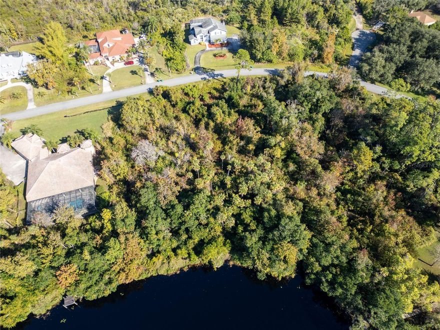 Discover the perfect place to build your dream home on this 1-acre homesite in the peaceful and highly desirable Rambling Acres West community. This spacious, tree-lined lot backs to reserved land, offering long-term privacy and a natural backdrop that feels like your own slice of untouched Florida.A tranquil pond view enhances the sense of serenity, and with city water available, underground utilities, and a low monthly HOA, this property blends beauty with practicality. The surrounding area is known for its wide-open feel, quiet streets, and well-maintained homes—ideal for anyone seeking space, nature, and a slower pace without sacrificing convenience.Located just minutes from Fox Lake Park, you’ll enjoy easy access to kayaking, fishing, nature trails, and community events. And if you’re connected to the aerospace industry or simply fascinated by it, you’re in the heart of it all—Titusville is thriving, with the growing space program bringing new energy, opportunity, and innovation to the region.Design your ideal Florida lifestyle here: morning coffee overlooking the water, a workshop or garden of your own, and room to create the home you’ve envisioned. Come walk the property and feel what makes Rambling Acres West so special. Adjacent parcel also available for sale.