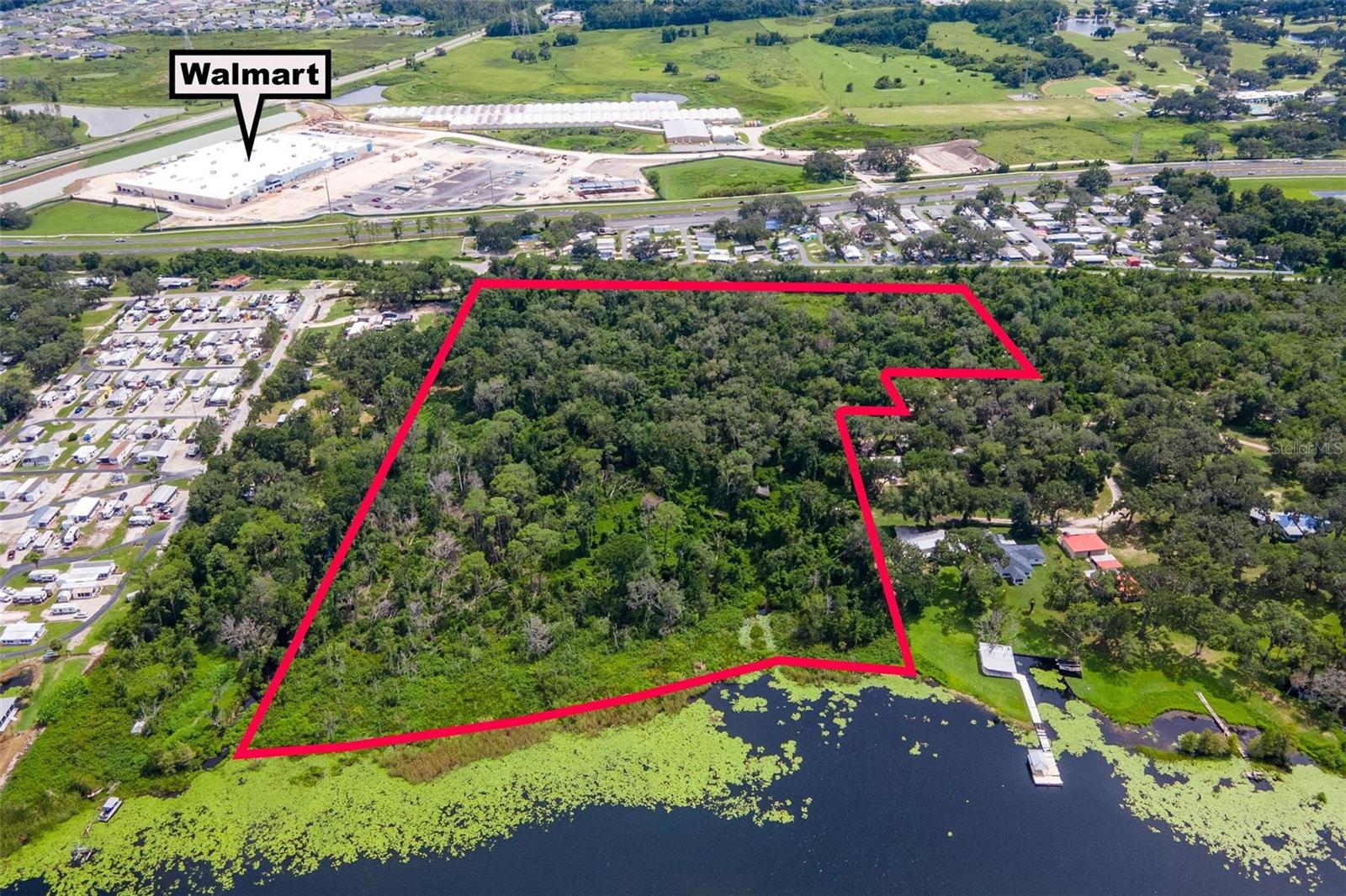 17.5 wooded acres of direct lakefront property on the pristine Lake Deaton. This is a rare opportunity to purchase this large of a parcel directly on an approximately 500 acre Lake. This offering is for two parcels, Sumter County ID: G23-050 and G23-022, currently zoned RR5 within Sumter County. Imagine the potential that this land offers with its close proximity to the new Walmart just on the other side of SR44, also nearby hospitals, medical plazas, shopping, The Villages, and so much more. With proper rezoning and possible annexation, an ALF or an RV park could be a great fit with an incredible view of Lake Deaton. There is an old mobile home, barn, and well on site, but the land is the value. All information provided is assumed to be accurate but must be confirmed by the buyer.