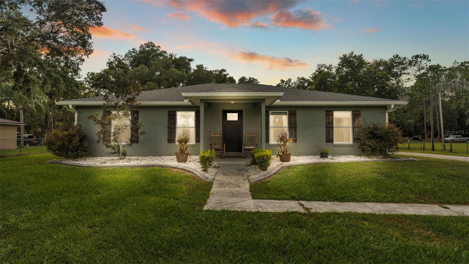 Escape to the tranquility of country living with this exquisite property, nestled on a sprawling 2.5 acres in Lakeland, Florida. Built in 2020 by C. Harwell Construction, this home perfectly combines modern elegance with the charm of rural life, offering an idyllic retreat for those seeking space and serenity. Plus, enjoy the freedom of no HOA, allowing you to fully embrace your lifestyle without restrictions.
As you step through the front door, you are greeted by an open floor plan that exudes warmth and spaciousness. The luxury vinyl plank flooring flows seamlessly throughout the entire home, providing a stylish and durable foundation for your living space. Each of the three generously sized bedrooms is large enough to accommodate a king-size bed, ensuring comfort for family and guests alike.
The heart of the home is the kitchen, complete with recessed lighting, stainless steel appliances, and a double oven- perfect for culinary enthusiasts! The stone countertops and oversized island provide ample workspace, while the closet pantry and bar area offer additional storage and seating options for entertaining.
Retreat to the master suite, featuring his and her closets and a luxurious bathroom! Unwind in the garden tub or enjoy the spacious shower, complemented by dual vanity sinks and elegant light fixtures.
Step outside to discover the best part of this property! Enjoy fishing at your very own stocked pond, complete with a stunning waterfall feature, or enjoy the rope swing and zip line for endless fun and adventure! The expansive grounds are also home to local wildlife, including deer and turkey, offering a unique opportunity to connect with nature right in your own backyard. The property also features a 30X40 pole barn equipped with power, and a 12X24 storage shed with its very own bathroom, making it ideal for outdoor activities. Plus, with an RV hookup available, you can easily accommodate guests or embark on your own adventures without leaving home. With plenty of room to roam and entertain, this home is a rare find in Lakeland. Don't miss the opportunity to make this property your own!