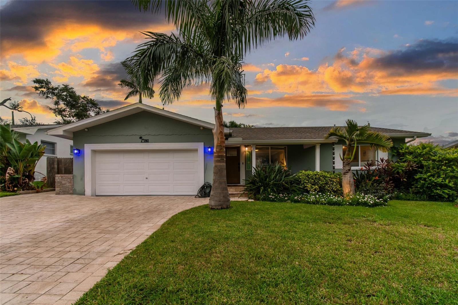 Welcome to your dream entertainer’s paradise at 2961 Fountainhead Dr, the epitome of Florida living. This stunning home showcases impressive curb appeal with a paver driveway and vibrant tropical landscaping, featuring majestic Florida palms that gracefully wrap around the property. Newly enhanced landscape lighting creates a tranquil, inviting ambiance during evening hours.
A paved walkway leads you to the ultimate backyard oasis—a tropical haven featuring one of the area’s most impressive island-style Tiki Huts. Spacious enough to seat at least 10 of your closest friends, this Tiki Hut is wired for electricity, complete with outlets, lighting, and even a couple of neon bar lights and a TV, all left by the sellers. It’s the perfect spot for evening cocktails, gatherings, and cookouts. Continue along the paver pathway to the fire pit, ideal for roasting marshmallows and enjoying cozy winter nights under the stars.
Step inside through the brand-new high-end contemporary front door and be welcomed into a bright, open living and dining area that seamlessly flows into the refreshed Florida Room. This versatile flex space, filled with natural light from wall-to-wall windows, can serve as a guest room, office, playroom, or anything your heart desires.
The updated kitchen boasts beautiful granite countertops, sleek high-end black stainless Samsung appliances, and a newly installed hurricane-rated sliding glass door that opens to your backyard paradise. Recent kitchen refreshes enhance its modern appeal, making it a true culinary delight.
On the opposite side of the home, you'll find two generously sized bedrooms separated by a beautifully remodeled bathroom featuring contemporary, on-trend finishes. The ceilings throughout the home are elegantly finished and stand just over 8 feet tall, adding to the spacious feel.
The attached two-car garage offers ample storage and durable garage tile flooring. Just inside from the garage, you'll find an updated second full bathroom and a convenient laundry room connected to the kitchen.
Numerous upgrades enhance this exceptional home, including:
Roof, soffits, gutters, and porch columns replaced in 2016
Paver driveway, porch, walkway, and patio added in 2016
New AC installed in 2021
Main bathroom remodeled in 2023
Recent refreshes to the kitchen and Florida Room
Perfectly positioned in unincorporated Largo, FL, this home is just minutes from Belleair Causeway boat ramps, marinas, fine dining, pubs, shops, the Pinellas Trail, parks, golf courses, and only 2.5 miles from the world-renowned sugar-soft white sand beaches of the Gulf of Mexico.
This truly one-of-a-kind home awaits its next owner—don’t miss this incredible opportunity!