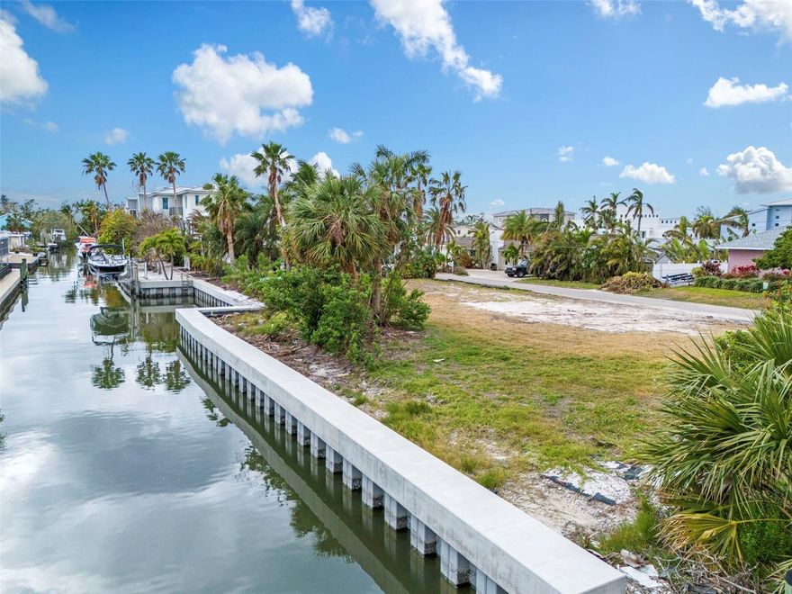 Build Your dream waterfront home on North Longboat Key! Discover an exceptional opportunity to create your custom coastal retreat on this build-to-suit lot with 120 feet of waterfront frontage. The property is primed for development, with a permit filed and approved. Architectural plans by Sweet Sparkman Architecture and Interiors, renowned for their innovative designs that harmonize modern luxury with the beauty of Florida's coastal landscapes. The thoughtfully designed floor plan ensures a seamless flow for everyday living and entertaining, capturing breathtaking water views from key living areas. Whether you’re relaxing indoors or stepping out to enjoy the vibrant outdoor spaces, this home has been envisioned to maximize its unparalleled waterfront location. Key features include a new seawall in 2023 that provides a solid foundation for waterfront living. Deeded beach access, just a short distance away, offers private enjoyment of pristine sandy shores on Longboat Key. Boating enthusiasts will appreciate the ample frontage for a dock and boat, providing easy access to Sarasota Bay and beyond. On sought-after North Longboat Key, the property offers proximity to acclaimed restaurants like Shore, Whitney’s and Mar Vista, ensuring dining and entertainment are always nearby. This is your chance to bring a remarkable vision to life in one of Florida’s desired locations. Schedule your private showing today and imagine the possibilities.