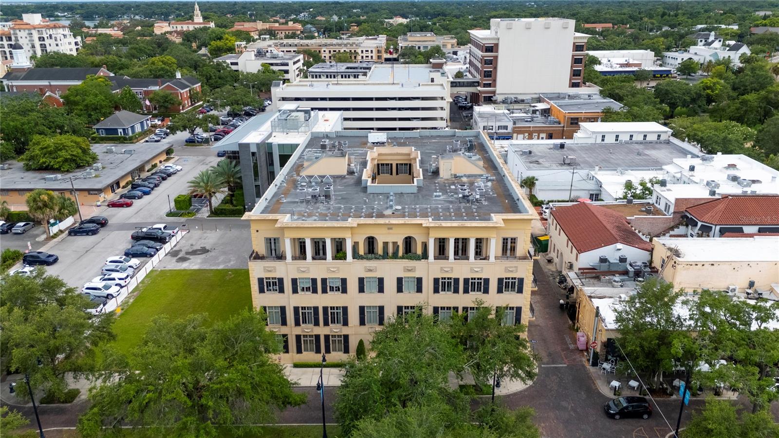 When you enter through the secure and elegant wrought iron gates and walk into in the private central courtyard, you'll feel the sophistication of The Landmark Winter Park. Take the elevator to the second floor and your private entrance balcony overlooking the courtyard. Inside, this spacious corner unit you'll find 2 bedrooms, 3 full bathrooms and a spacious media room/office. From the foyer look through the large dining and living room space to windows overlooking shady Morse Boulevard. This unit lives large with the floor plan nicely splitting the primary suite, second bedroom and media room/office for maximum comfort and privacy. And perhaps most impressive of all is the large, bright kitchen with huge center island, loads of counter space and storage, Sub Zero refrigerator, KitchenAid 6-burner gas range and wine cooler. Twelve-foot ceilings and large windows throughout add to to the spacious, luxurious feeling. The massive primary suite is truly a retreat, with French doors opening onto the private balcony from the bedroom, large spa-inspired bathroom and fully built-out walk-in closet. Bedroom two, on the other side of the condo also has a walk-in closet and a generous bathroom with step-in shower. The office/media room is large and private, completely separate from the bedrooms, with direct access to the third bathroom. Laundry/utility room with rear exit door is away from the living space and has lots of storage. Two dedicated parking spaces in the secure underground garage, and each unit has its own climate controlled storage space for bicycles and other large items. The Landmark Building is Winter Park's premiere address. Luxury, privacy and proximity to all Park Avenue is known for, including boutique shopping, cafes and fine dining, as well as Central Park and Rollins College with many events and programs throughout the year. Easy access to Central Florida's highways, and SunRail station just steps away. Luxury living in Winter Park, it is here in The Landmark.