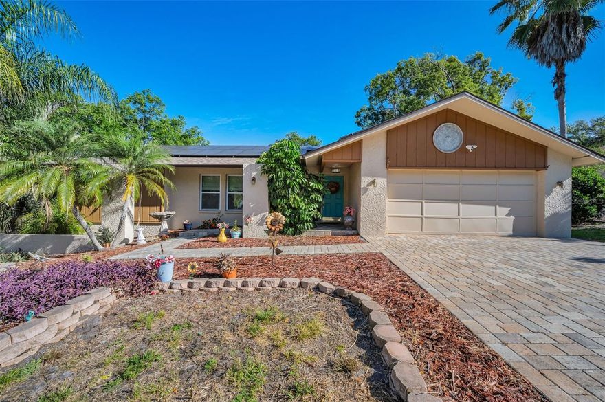 One or more photo(s) has been virtually staged. Location, location, location! Private pool home backing to Park in Westlake Village Community! This 3 bedroom/2bath home is located in one of Palm Harbors most sought-after communities! This home is a rare find in that it backs up to the community park with no rear neighbors and complete privacy! Situated minutes from community clubhouse, junior Olympic size pool, tennis and pickleball courts, basketball and volleyball courts, playground and over 30 acres of serene nature trails. This home combines comfort and privacy. The kitchen sits at the heart of the home featuring solid wood cabinetry, granite countertops and stainless-steel appliances. Not to mention a gas stove and built in beverage cooler. Perfect for everyday meals or hosting get togethers. The split bedroom plan ensures privacy for all. Primary suite includes walk in closet, ensuite bath and serene views of the pool and park. Two guest rooms share a full bath. The eat-in kitchen overlooks the pool and family room which includes a wood-burning fireplace and skylights that fill the room with natural light. Step inside to an oversized living and dining room- perfect for hosting gatherings or creating a dedicated home office space. An interior laundry room with additional storage adds convenience to everyday living. Outside, enjoy you own private backyard oasis with mature landscaping and Mexican tile pool deck. Living in Westlake Village means embracing a true sense of community, with low HOA fees, a wide range of amenities, and a golf cart friendly, highly walkable neighborhood. Additional highlights include a 2018 roof and solar panels, helping to keep energy costs low. This home is zoned for top-rated schools, NO flood zone and minutes from the Pinellas Trail, downtown Palm Harbor with restaurants and nightly sunset. Close to Honeymoon Island, Dunedin, Tarpon Springs, award winning beaches, shops, restaurants, hospitals and TIA. This home truly combines convenience with a peaceful setting. Call for a showing today!