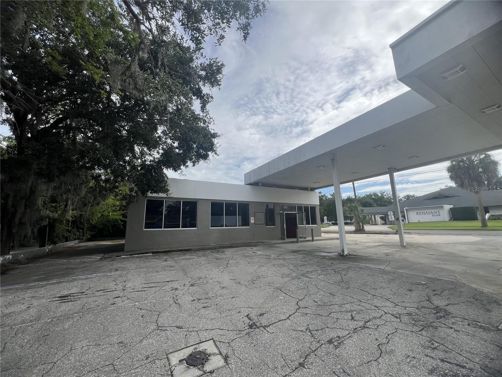 Once a bustling gas station, this site now presents a rare investment opportunity in a high visibility, high-traffic area. Only one mile from historic downtown Ocala! Situated on a generous corner lot directly on Silver Springs Blvd this is a prime location with steady vehicle and foot traffic. This property includes a 1555 sq ft building with open-interior space, large display windows, and a covered 1525 sq ft pump canopy prefect for creative reuse. With city utilities already in pace and flexible zoning (verify with local municipality), it's ideal for investors or entrepreneurs looking to transform the space into a profitable venture. Zoned for commercial use, its perfect for a unique retail shop, café, brewery, restaurant, salon, etc. Whether you’re looking to restore, repurpose, or redevelop, this property offers a solid foundation.
This site currently has a closed in place underground fuel tank approved by the state. The tank is filled with grout therefore not useable. The environmental condition has a minimal impact on redevelopment. Seller will provide latest reports and help buyer with appropriate state agency contacts for further information. Sold as is- ready for your vision.