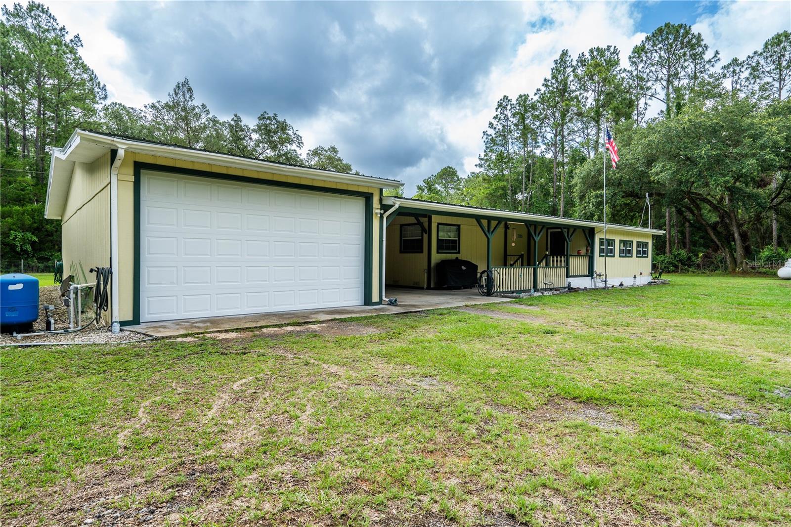 Don't let the age fool you! This home has been remodeled from top to bottom from the galvalum metal roof to all new flooring. taped and textured drywall, new bathroom fixtures, new kitchen cabinets and countertops, new appliances. Spacious rooms, Lg, fully enclosed front and rear porches. 15x43 attached drive thru carport plus an 18x 43 drive thru garage - work shop and a 24x 35x 14' high RV Port. Whole house generac generator. Fully fenced one acre yard with electric gates front and rear. Property goes from street to street on dead end streets. Less than 2 miles to The Eureka boat ramp on The Ocklawaha River and The Ocala National Forest