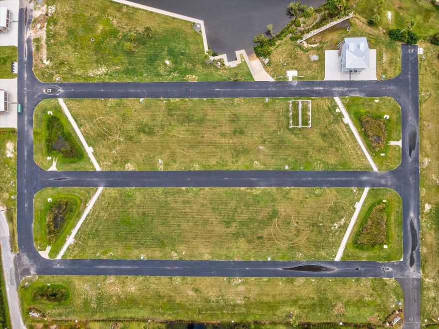 Waterfront & Dock Potential
Deep-water canal connects directly to the Gulf of Mexico with approximately 20-minute boat ride to open water

Seller initiated construction with Dock, sea wall and boat ramp

Build-Ready Condition
Fully cleared, compact soil; includes existing survey, geotechnical report, and architectural home plans (available to buyer)

All utilities nearby: electricity, telephone, water, sewer; roads lit and paved up to the site

Location & Lifestyle
Nestled adjacent to Boy Scout Preserve with boardwalk trails — enjoy serene nature right out your doorstep

Just a minute’s walk to Robert K. Rees Memorial Park featuring sandy beaches, fishing piers, and stunning sunset views

Conveniently situated off US-19, near the revitalized downtown of New Port Richey with shopping, restaurants, entertainment

Financial Highlights
List Price: $39,500.00

Ideal Buyer Profile
This is a rare chance for discerning buyers—boaters, waterfront enthusiasts, or custom-home seekers—to build a private estate tailored to their vision, with turnkey waterfront potential in an exclusive gated setting.