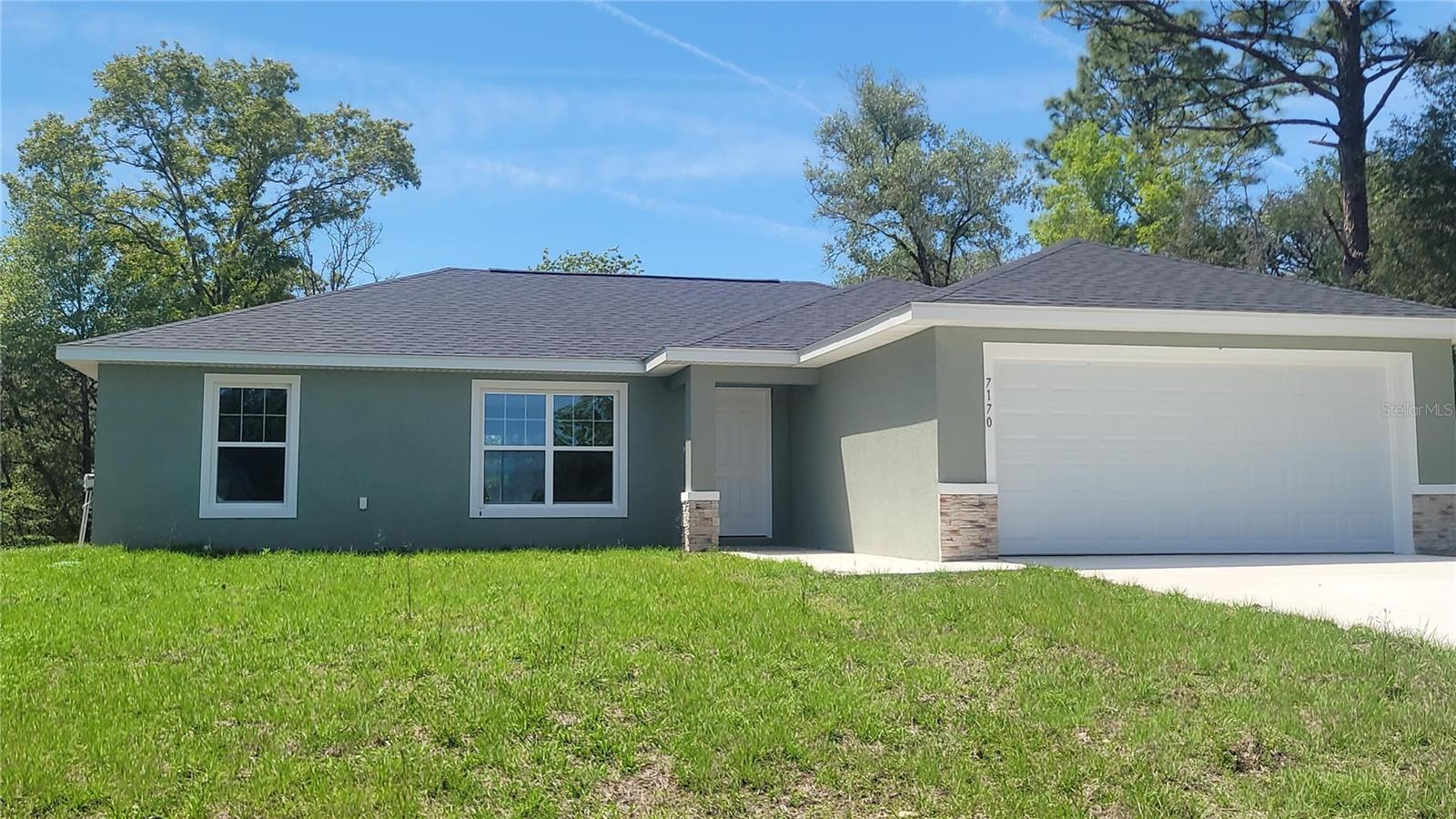 One or more photo(s) has been virtually staged. MOVE IN READY!!! One of the cheapest new construction homes in Citrus Springs, you won't find a better deal. Beautiful new construction on big, private lot! No neighbors to the left, right, or behind. Just a block off of the main Citrus Springs Blvd, 1 mile from Citrus Springs Community Center, and 2.5 miles from the Citrus Springs Trail Head connecting to the Withlacoochee Riding Trails. Luxury Plank Vinyl flooring throughout all living and common areas, tile in bathrooms, and carpet in the bedrooms. Open floor plan with dining area and eat-in kitchen, all done in neutral, pleasing colors. Inside laundry with W & D hook-ups. Walk-in closet in Master bedroom. Stainless steel appliance package in the kitchen. Cabinets are white shaker-style with light luxury quartz countertops. This home is bright, clean, and beautiful. Please see attached documents from Builder (Builders Contract Addendum & Warranty) Actual photos + staged model home for reference.