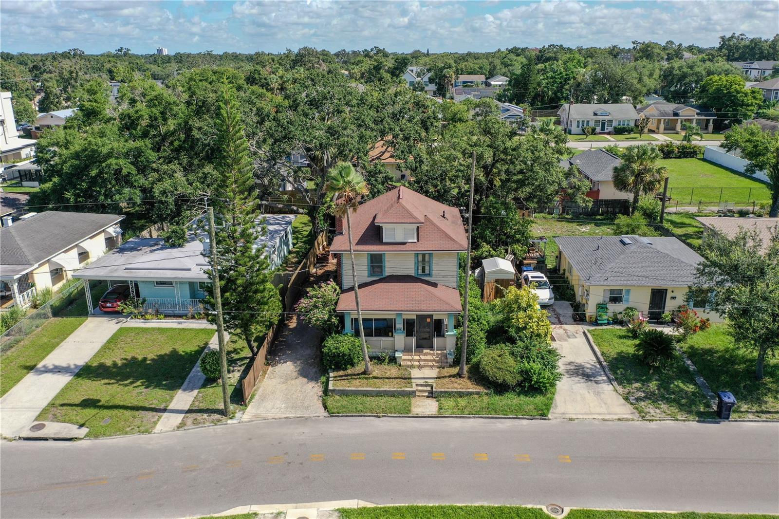 Welcome to a remarkable opportunity in the heart of Tampa Heights, where urban living meets serene charm. This five-bedroom, three-bathroom home is situated just a block from the picturesque Riverwalk and is in close proximity to some of Tampa’s most sought-after destinations. Imagine enjoying breathtaking skyline views from your own front porch, a perfect backdrop for both relaxation and entertaining. The property features a unique converted garage that offers a versatile one-bedroom, one-bathroom space. This area can serve as an in-law suite, guest house, or even a source of rental income, providing you with flexibility and options for your lifestyle. Whether you choose to personalize this inviting residence to suit your tastes or seize the potential of this prime lot to build your dream home, the possibilities are endless. Embrace the vibrant community and make this exceptional property your own.