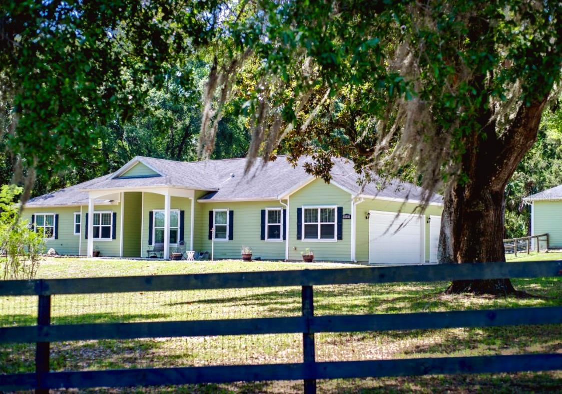 UPDATED PHOTOS have been added for this Rare Opportunity in Summerfield – Horse-Friendly Property with Modern Comforts and Prime Location in Bridle Trail Estates
Properties in this sought-after neighborhood rarely come to market—don’t miss your chance to make this beautifully appointed home your own. Bring your horses and enjoy a lifestyle of comfort, convenience, and country charm.
Ideally located just off Hwy 441 in Summerfield and minutes north of The Villages, this property offers nearby access to top local destinations including the Florida Horse Park, Downtown Ocala, and the World Equestrian Center.
Built in 2018, this spacious 3-bedroom, 2-bath home combines the appeal of modern construction with thoughtful, high-end extras. A climate-controlled 3-car attached garage is complemented by an additional 720 sq. ft. detached garage/workshop—also climate-controlled with soaring ceilings, perfect for hobbies, storage, or additional workspace.
The heart of the home is a gourmet kitchen featuring custom cabinetry with granite countertops, stainless steel appliances, a walk-in pantry, and a charming breakfast nook overlooking the backyard and paddock. The open-concept layout connects seamlessly to the bright living area and an oversized eat-in counter—perfect for entertaining. A generous dining area at the front of the home offers views of the sprawling front yard.
A well-appointed laundry room with built-in cabinetry and additional storage space is conveniently located off the kitchen. The spacious master suite serves as a peaceful retreat with dual walk-in closets, a soaking tub, walk-in shower, and double vanities. Two additional bedrooms and a stylish guest bath round out the interior space, with abundant storage including two hallway linen closets and a foyer coat closet.
Step outside to a covered back patio with roll-up sunshades—ideal for relaxing under the shade of mature oaks. Thoughtful upgrades throughout the property include a full-house GENERAC generator, hurricane shutters, automatic gated entry, security lighting, and gutters for added peace of mind.
Equestrians and pet owners alike will appreciate the perimeter fencing and cross-fencing, with a shaded paddock separate from both the front and back yards. A newer, oversized run-in shed can easily be divided into two stalls, offering flexibility for horse care.
This is more than just a home—it's a lifestyle. Schedule your private showing today and experience all that this exceptional property has for it's new family.